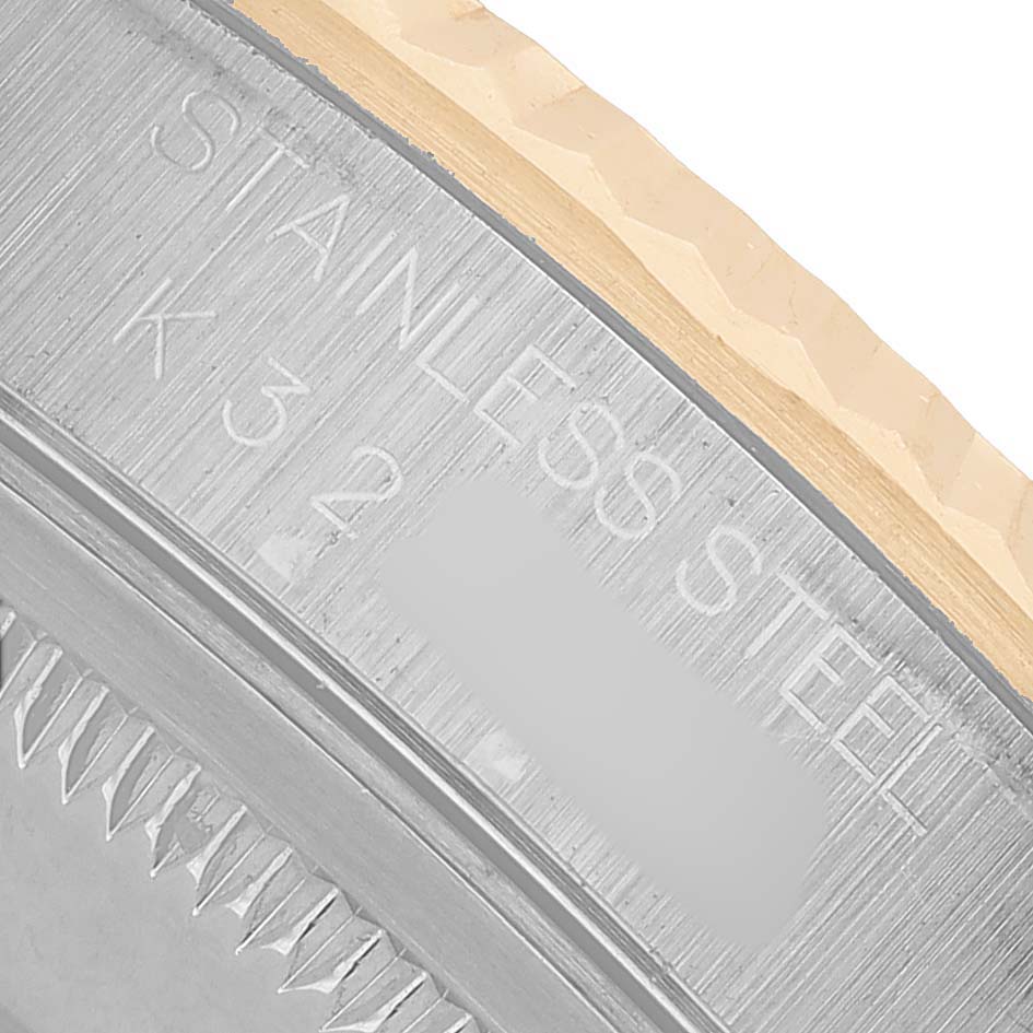 The image shows a close-up of the side and back edge of the Rolex Datejust 16233 Men's Steel and Gold (two tone) Silver Dial watch, highlighting the stainless steel inscription.