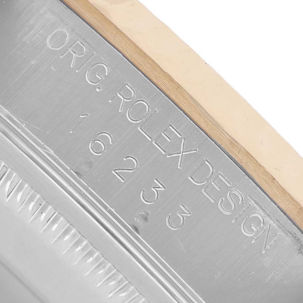 The image shows a close-up of the side of a Rolex Datejust 16233 Men's Steel and Gold (two tone) Silver Dial, highlighting the engraved model number and design markings.