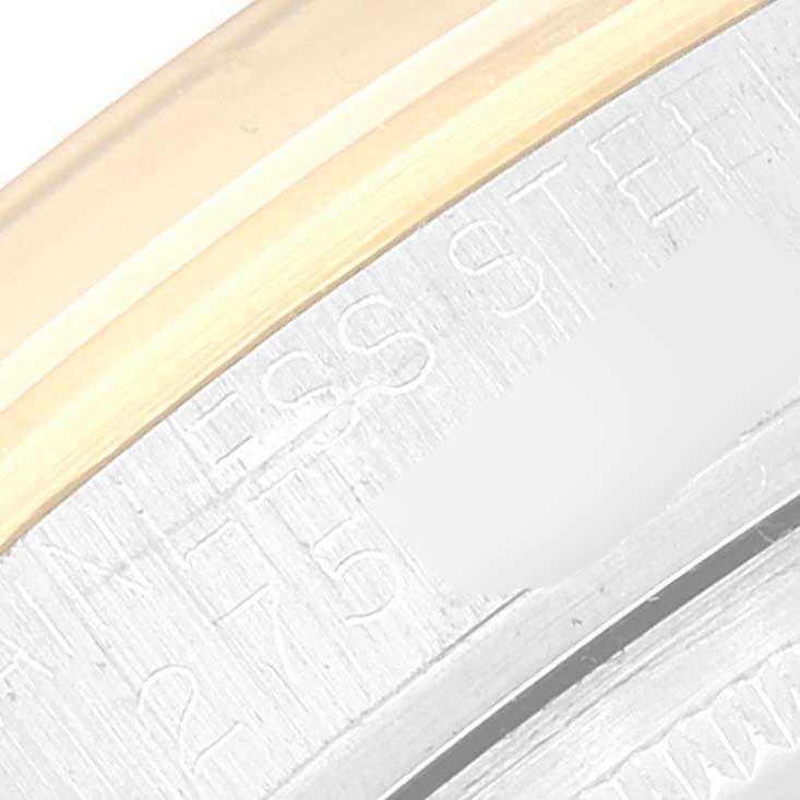 This image shows a close-up of the back case and part of the bezel of a Vintage Collection Rolex watch.