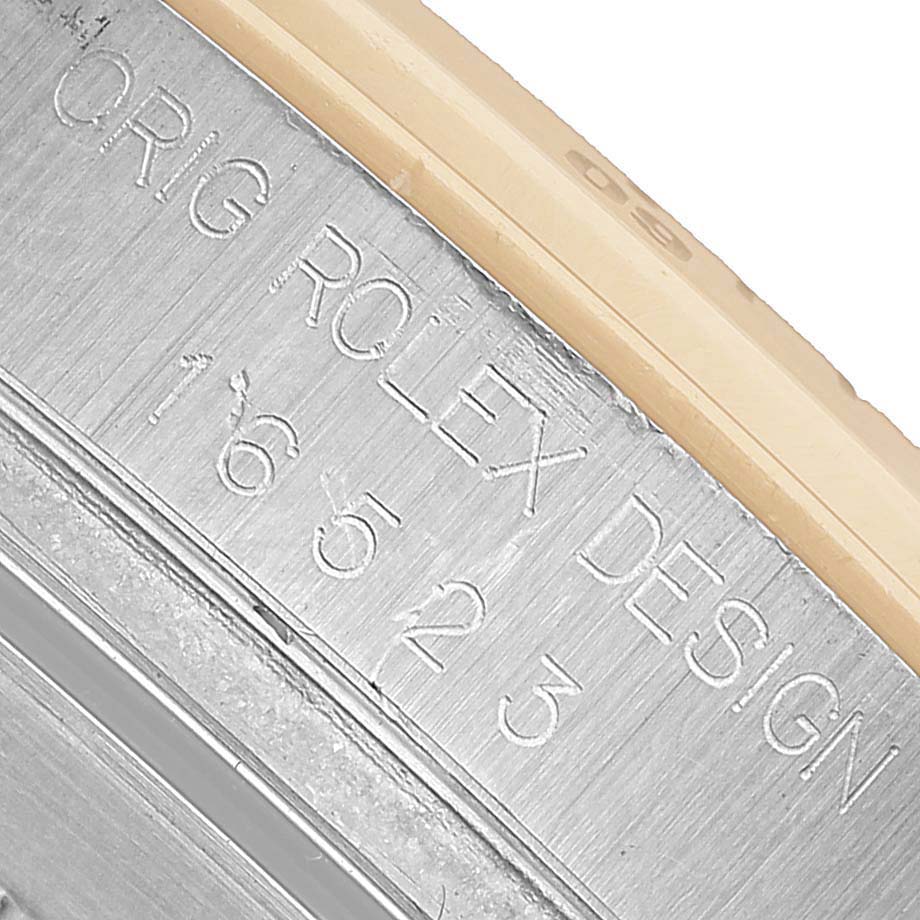 The image shows a close-up of the engraved side of a Rolex Daytona 16523 Men's Steel and Gold (two tone) White Dial watch case, highlighting the model number.