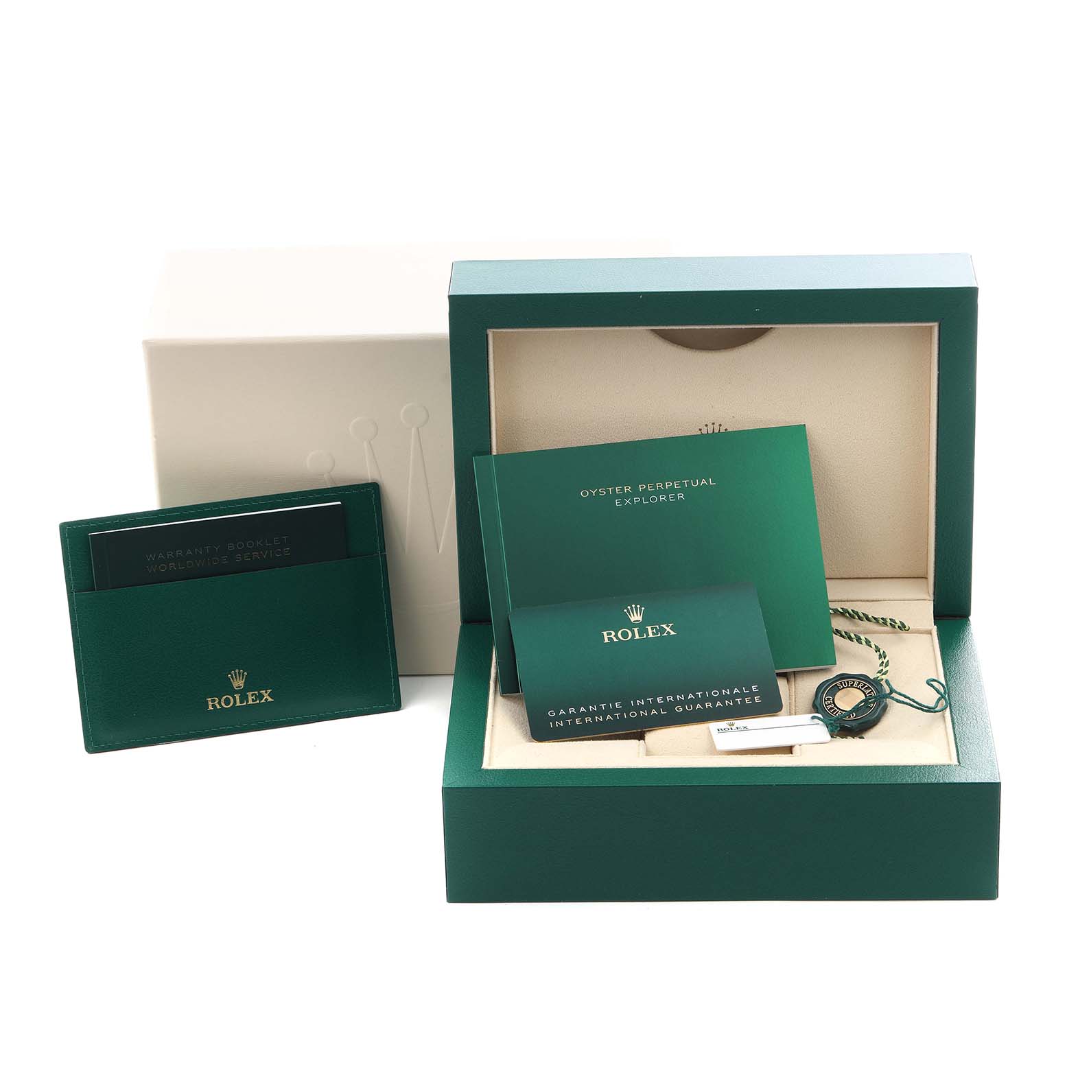 The image shows the packaging and accessories for a Rolex Explorer 124270 Men's Stainless Steel Black Dial 124270 Men's Stainless Steel Black Dial, including a box, booklets, and a tag.