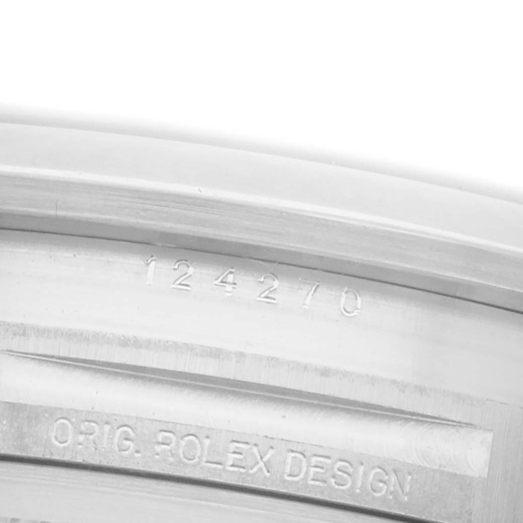 The image shows the engraved inner case side of a Rolex Explorer 124270 Men's Stainless Steel Black Dial 124270 Men's Stainless Steel Black Dial watch with the model number and "ORIG. ROLEX DESIGN."