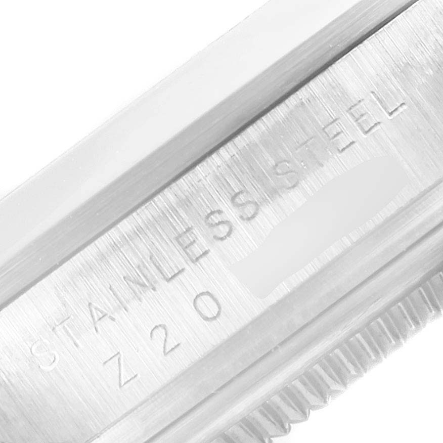 The image shows a close-up of the stainless steel bezel edge and part of the case of the Rolex Explorer 114270 Men's Stainless Steel Black Dial 114270 Men's Stainless Steel Black Dial watch.