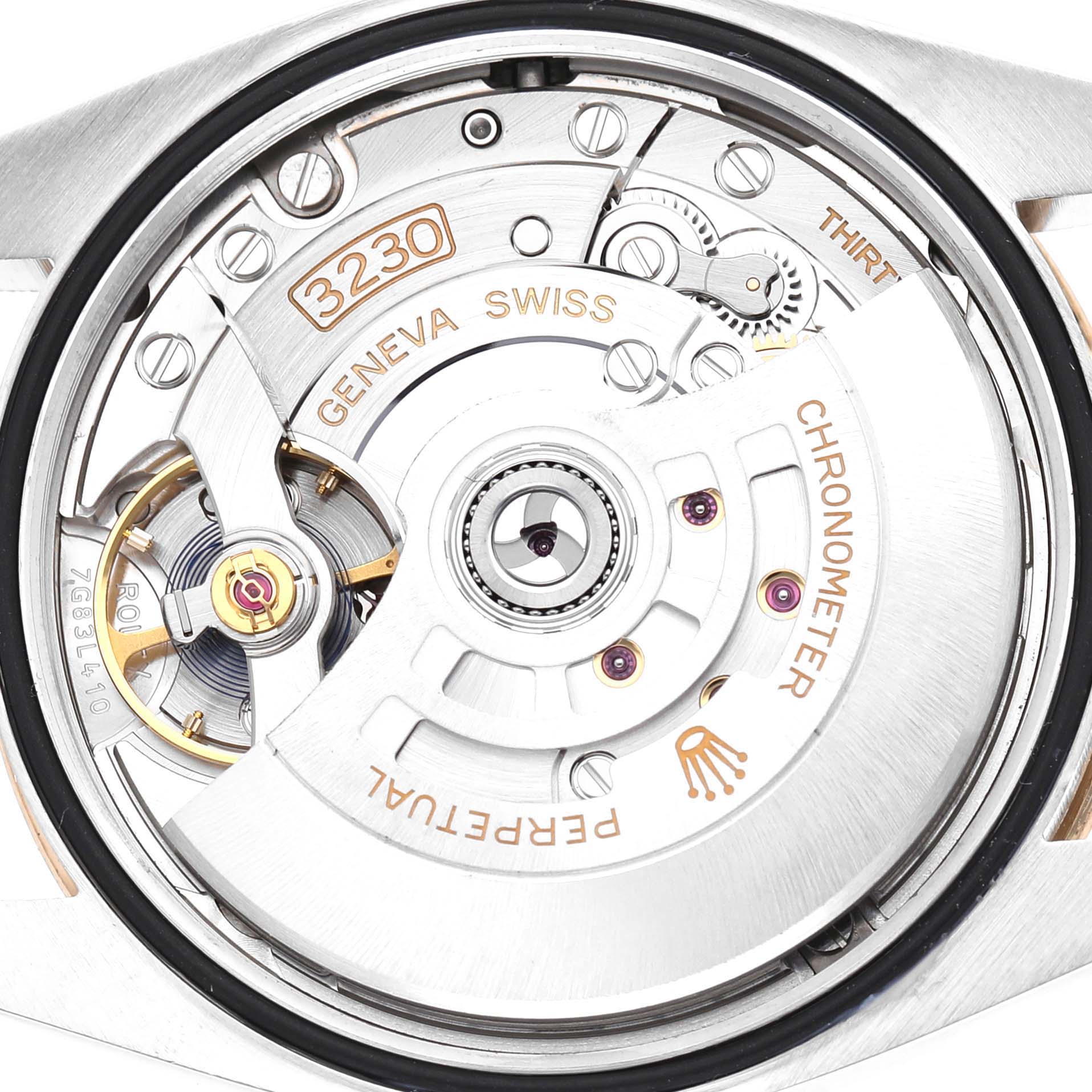 The image shows the open case back of a Rolex Explorer 124273 Men's Steel and Gold (two tone) Black Dial, highlighting the movement, balance wheel, and rotor.