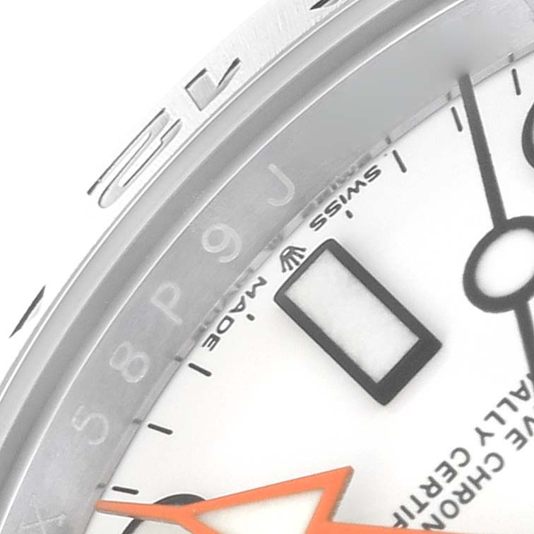 This photo shows a partial view of the face, bezel, and orange hand of a Rolex Explorer 226570 Men
s Stainless Steel White Dial 226570 Men
s Stainless Steel White Dial watch.