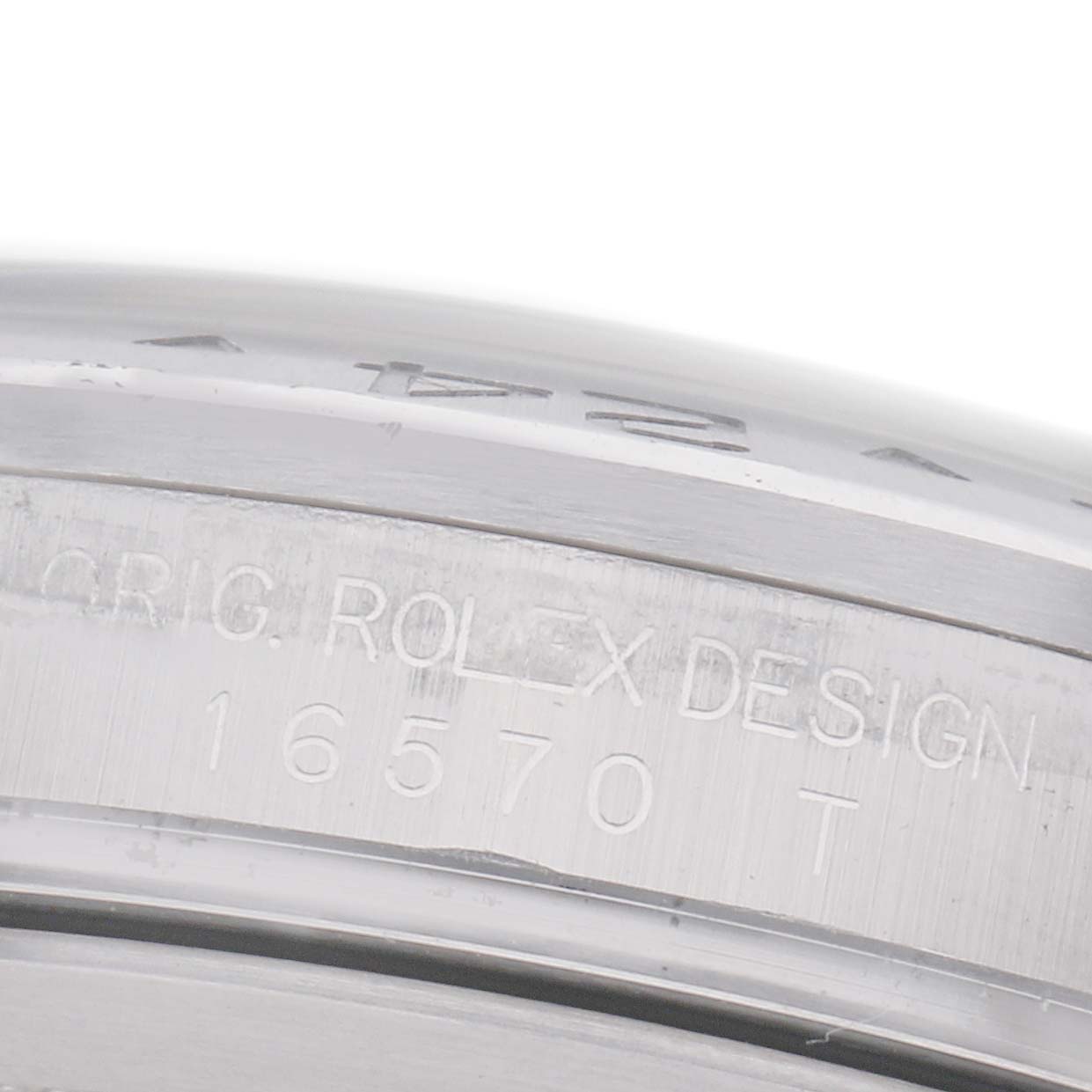 The image shows a close-up of the side engraving on the bezel of a Rolex Explorer 16570 Men's Stainless Steel White Dial 16570 Men's Stainless Steel White Dial model, featuring the original design and model number.