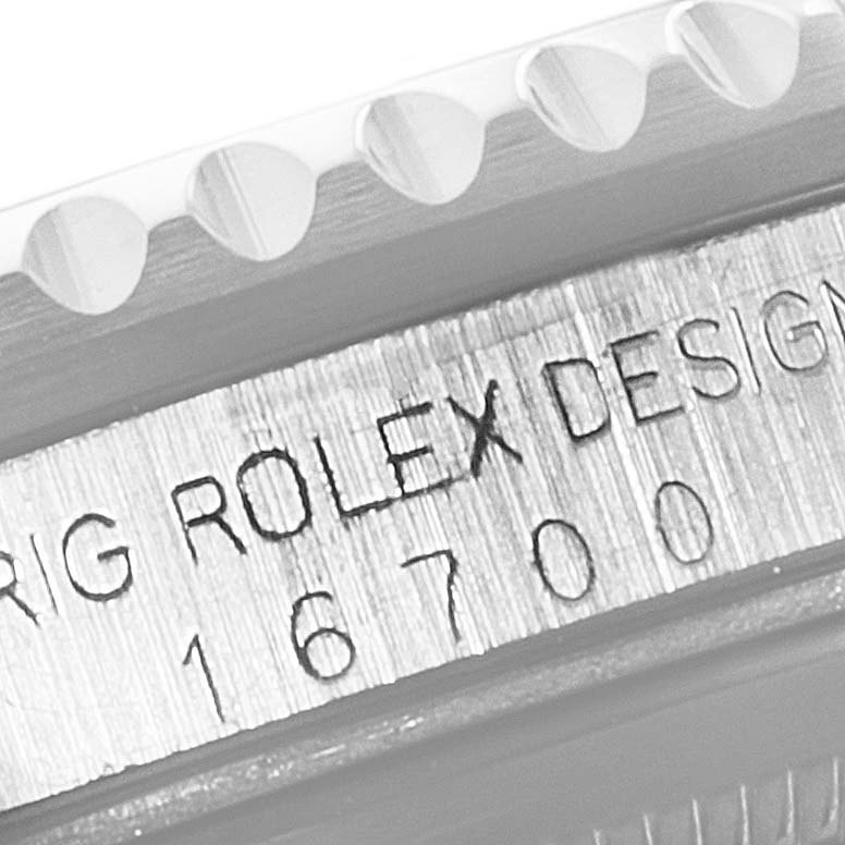 This angle shows a close-up of the engraved side of the case between the lugs of the Rolex GMT-Master 16700 Men's Stainless Steel Black Dial 16700 Men's Stainless Steel Black Dial model 16700.