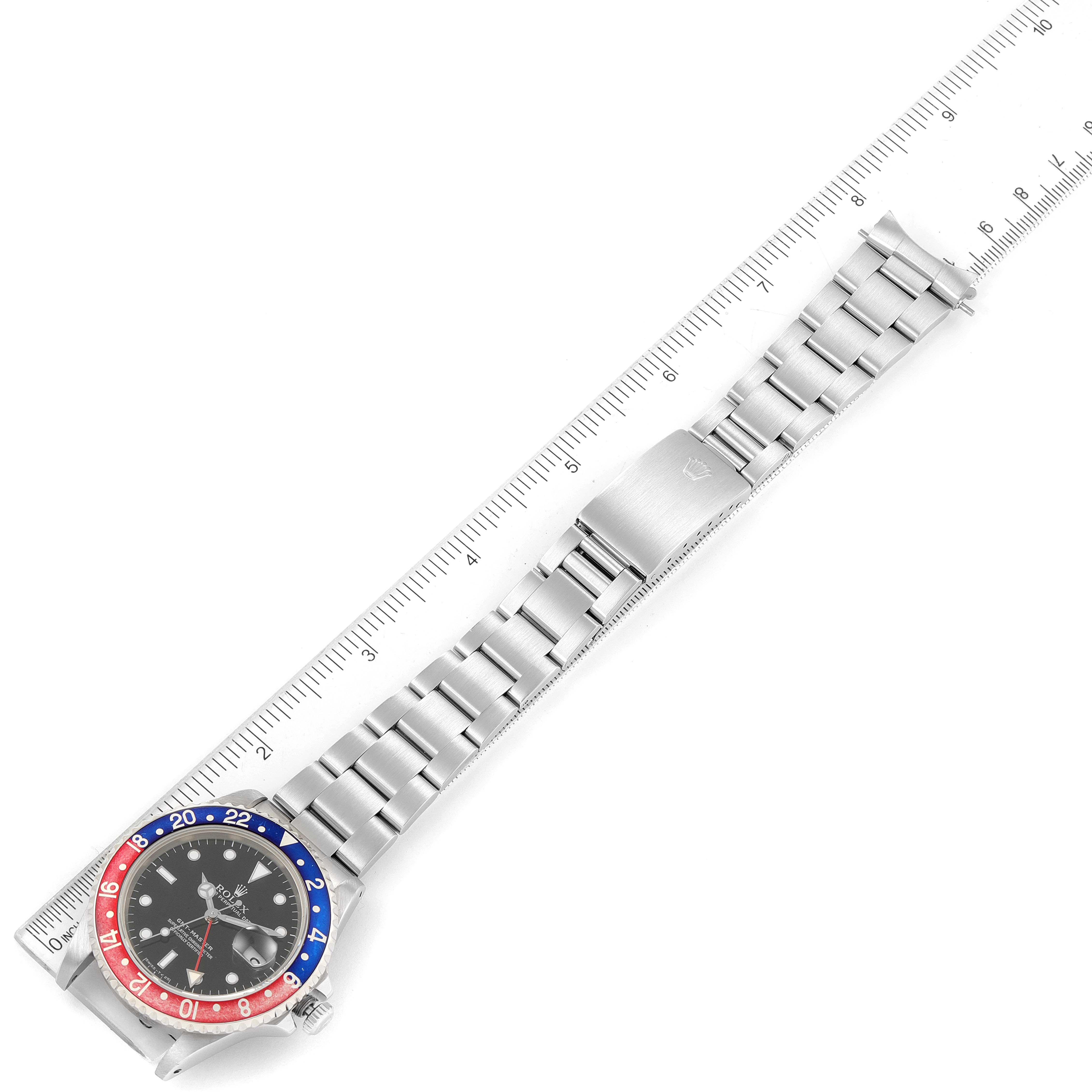 The Rolex GMT-Master 16700 Men's Stainless Steel Black Dial 16700 Men's Stainless Steel Black Dial watch is shown from an overhead angle, highlighting its face, bezel, and full metal bracelet with clasp.