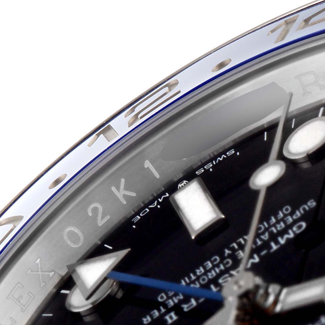 This close-up of the Rolex GMT-Master 126710 Men
s Stainless Steel Black Dial 126710 Men
s Stainless Steel Black Dial watch showcases part of the bezel, dial, and blue GMT hand.
