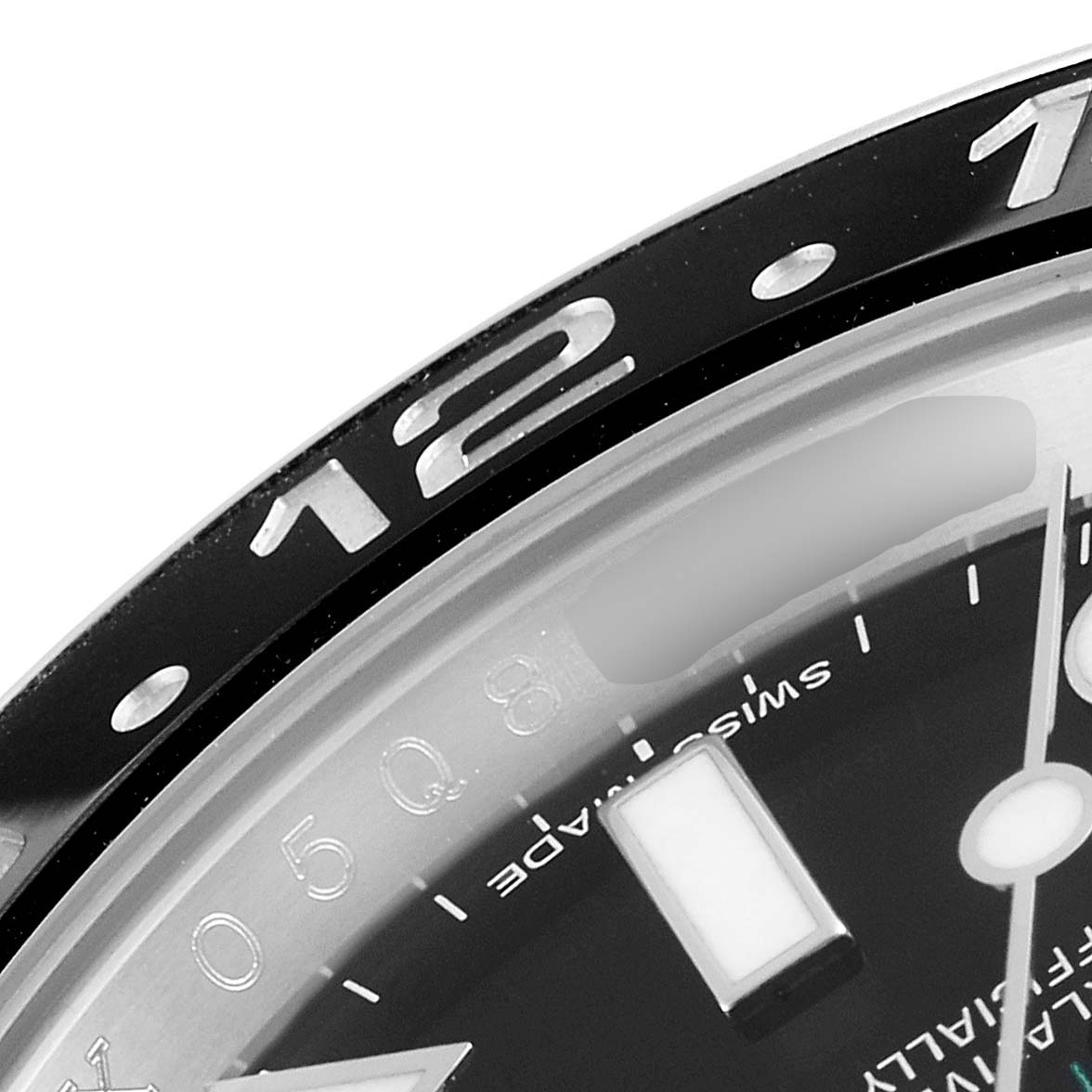 The close-up image of the Rolex GMT-Master 116710 Men's Stainless Steel Black Dial 116710 Men's Stainless Steel Black Dial shows the bezel and a portion of the dial with hour markers.