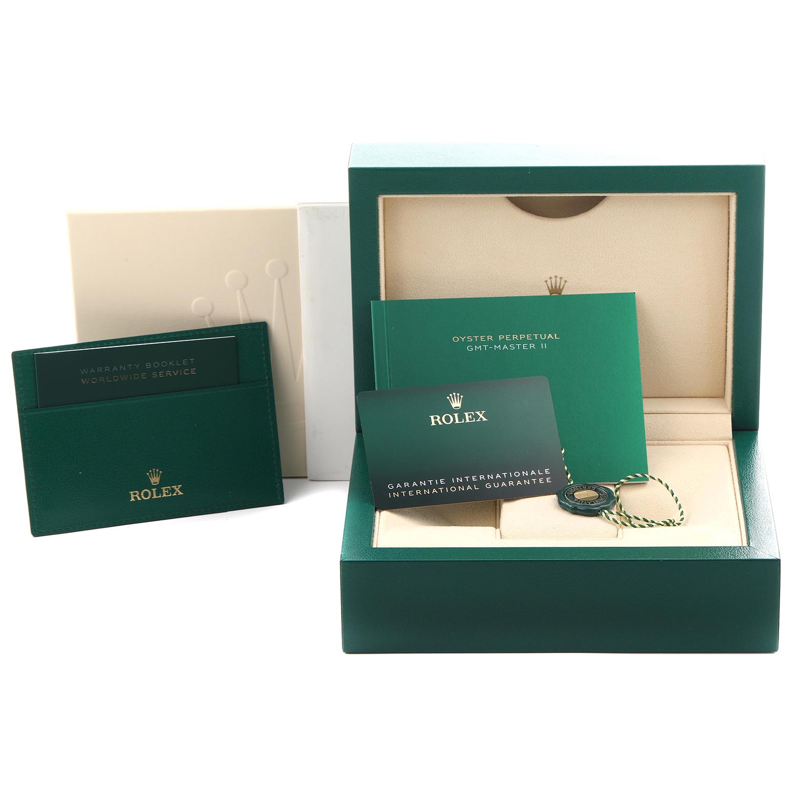 The image shows accessories for the Rolex GMT-Master 126710GRNR Men's Stainless Steel Black Dial 126710GRNR Men's Stainless Steel Black Dial model, including a box, warranty booklet, international guarantee card, and a tag.