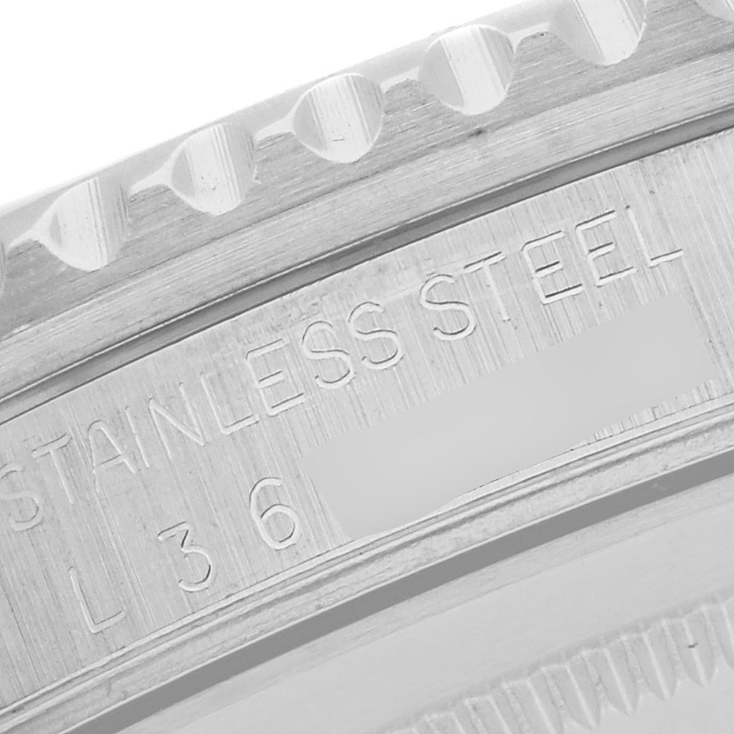 The image shows a close-up of the engraved stainless steel bezel and edge of a Rolex GMT-Master 16700 Men's Stainless Steel Black Dial 16700 Men's Stainless Steel Black Dial watch.