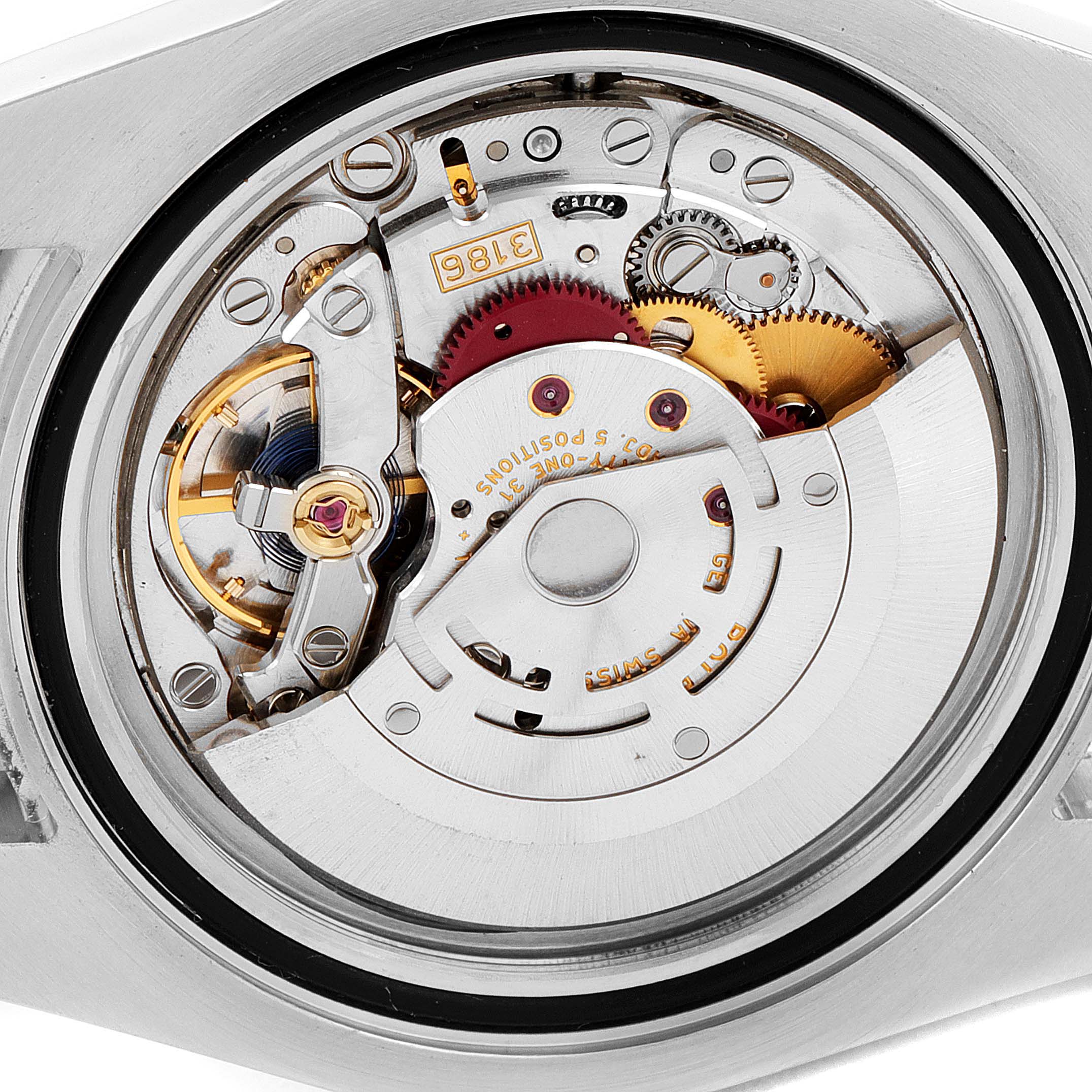 This is a close-up view of the movement from a Rolex GMT-Master 116713 Men's Steel and Gold (two tone) Black Dial 116713 Men's Steel and Gold (two tone) Black Dial watch, showcasing gears and intricate components.