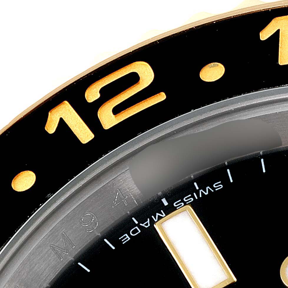 The image shows a close-up angle of the bezel and part of the dial of a Rolex GMT-Master 116713 Men's Steel and Gold (two tone) Black Dial 116713 Men's Steel and Gold (two tone) Black Dial watch.