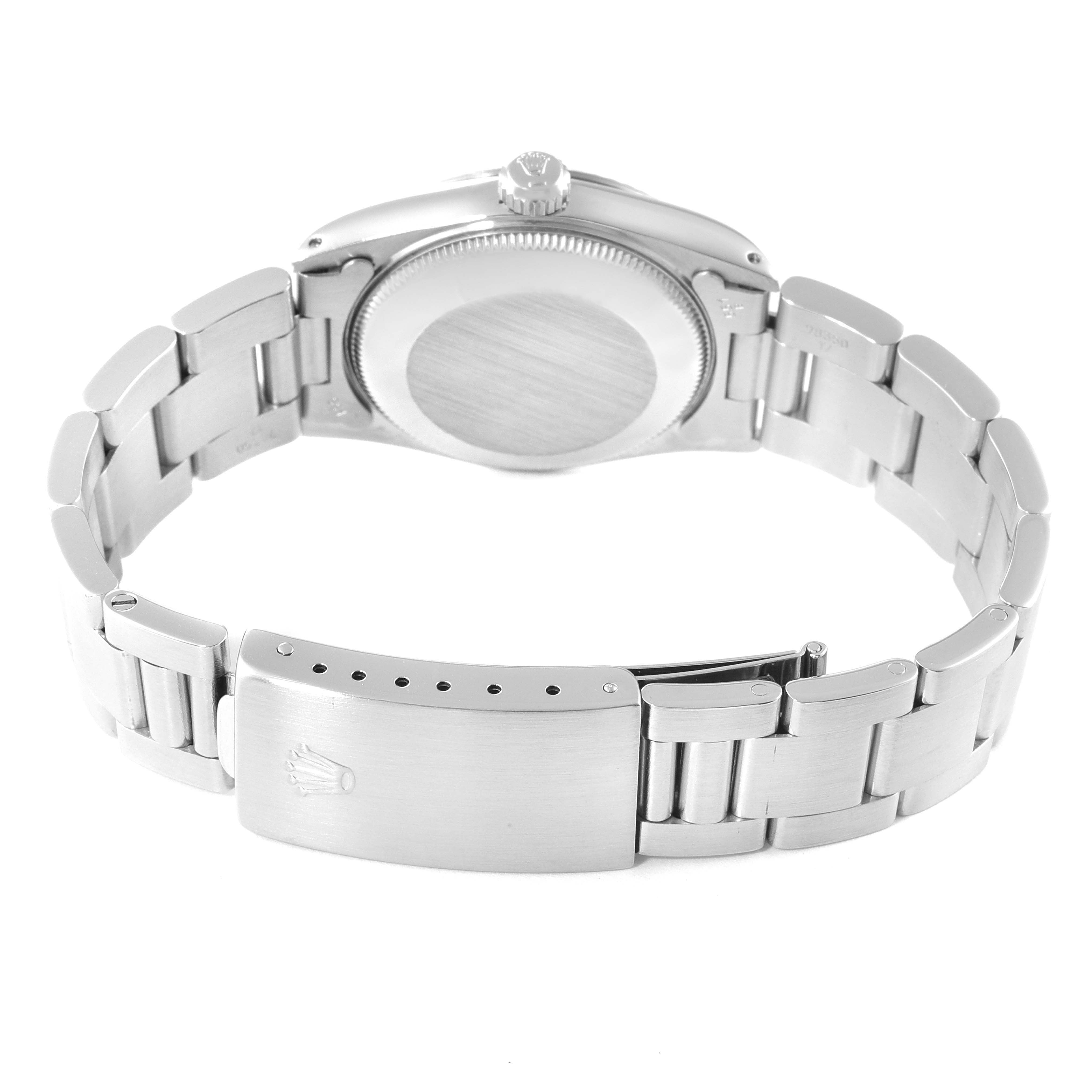 The image shows the backside of a Rolex Mid-Size 67514 Women
s Stainless Steel White Dial 67514 Women
s Stainless Steel White Dial watch, highlighting the clasp, bracelet, and case back.