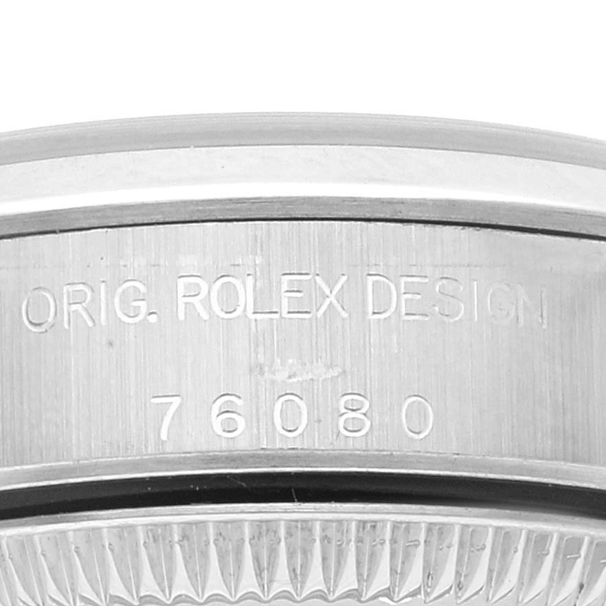 The image shows the side of the casing of a Rolex Oyster Perpetual 76080 Women's Stainless Steel Black Dial 76080 Women's Stainless Steel Black Dial watch, specifically the engraving that includes the model number "76080".