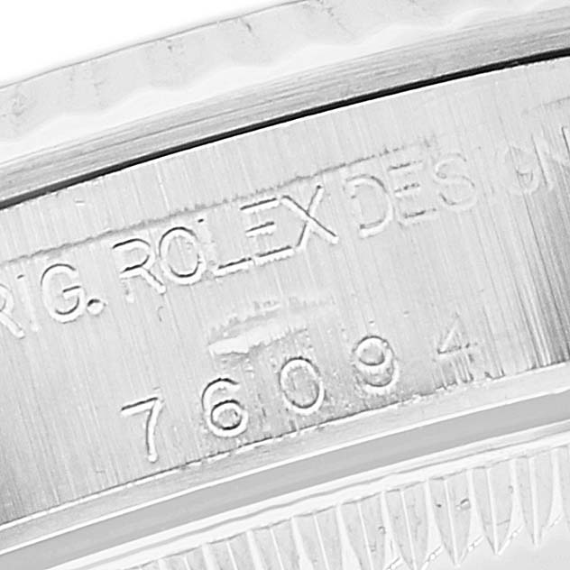 This close-up image shows the serial number engraving on the caseback of a Rolex Oyster Perpetual 76094 Women
s Stainless Steel Black Dial 76094 Women
s Stainless Steel Black Dial watch.