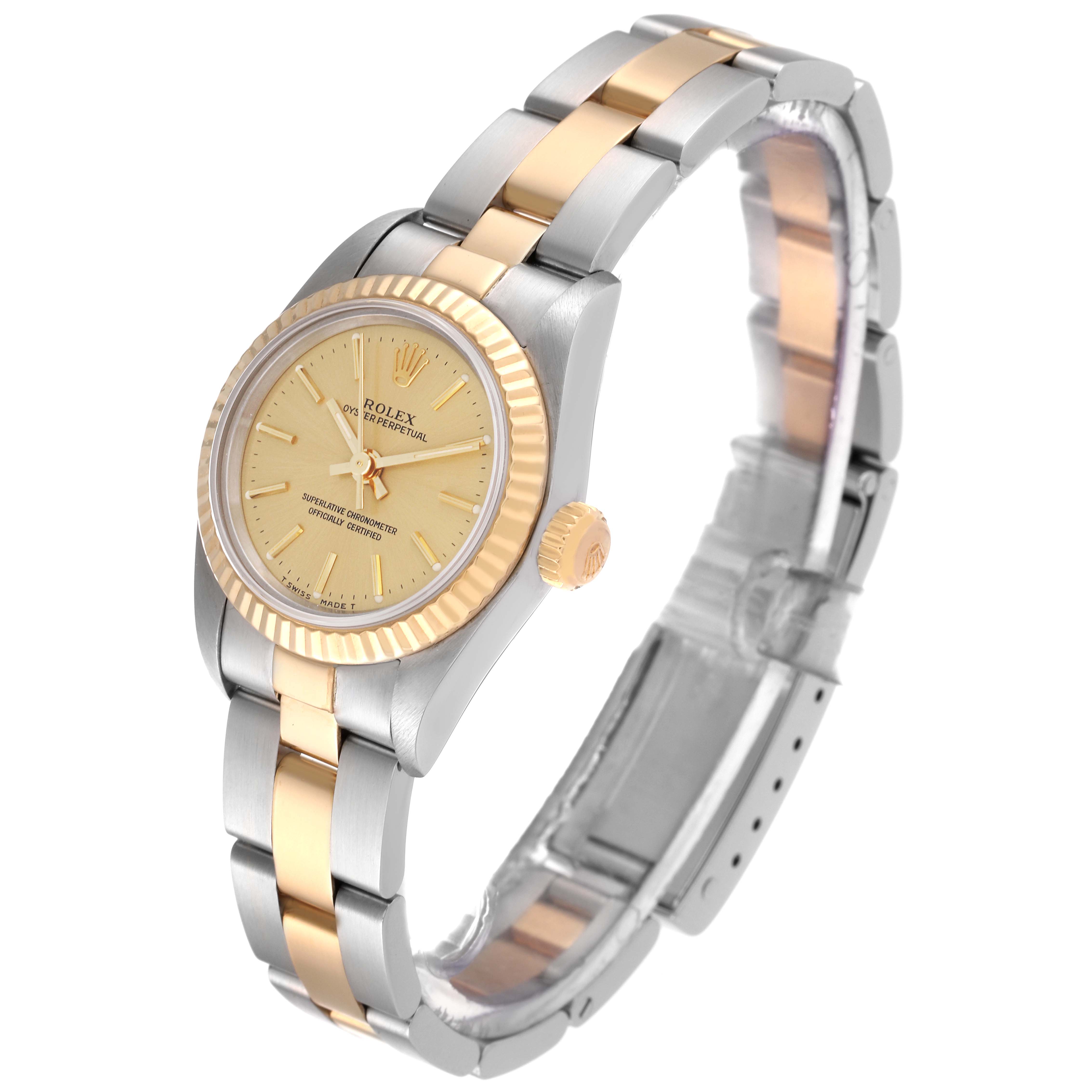 The Rolex Oyster Perpetual 67193 Women's Steel and Gold (two tone) Champagne Dial 67193 Women's Steel and Gold (two tone) Champagne Dial watch is shown at an angled side view, highlighting its dial, fluted bezel, crown, and bracelet.