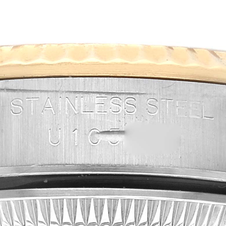 This image shows a close-up view of the engraved stainless steel edge of a Rolex Oyster Perpetual 67193 Women's Steel and Gold (two tone) Champagne Dial 67193 Women's Steel and Gold (two tone) Champagne Dial watch.