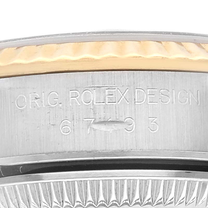 This close-up image shows the engraved side of the case of a Rolex Oyster Perpetual 67193 Women's Steel and Gold (two tone) Champagne Dial 67193 Women's Steel and Gold (two tone) Champagne Dial watch.