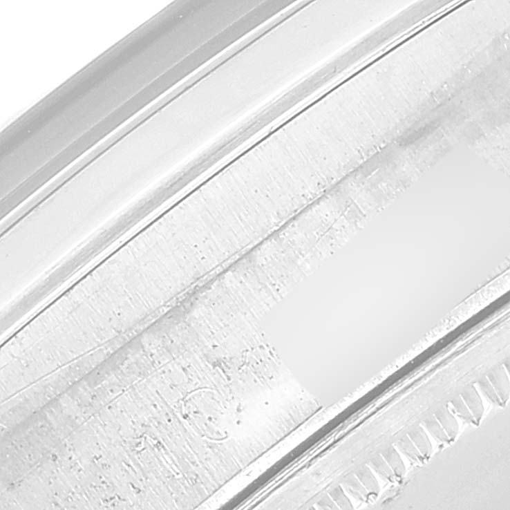 This close-up image shows the case edge, possibly including part of the bezel or backcase of the Rolex Vintage Collection 6694 Men's Stainless Steel Black Dial 6694 Men's Stainless Steel Black Dial model watch.