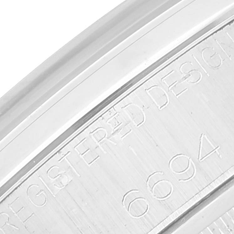 This is a close-up view of the engraved case side on a Rolex Vintage Collection 6694 Men
s Stainless Steel Silver Dial 6694 Men
s Stainless Steel Silver Dial model 6694 watch.