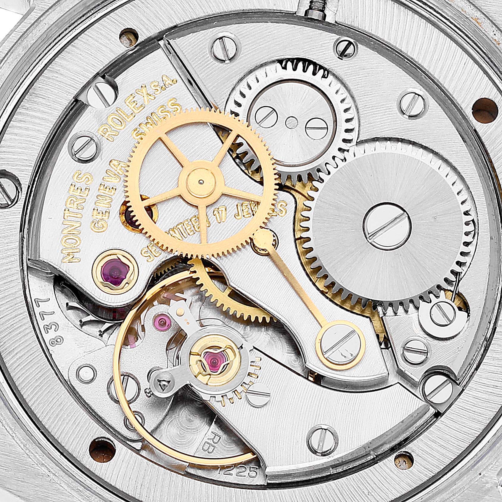The image shows a close-up view of the intricate internal movement of a Rolex Vintage Collection 6694 Men
s Stainless Steel Silver Dial 6694 Men
s Stainless Steel Silver Dial watch, highlighting gears and jewels.