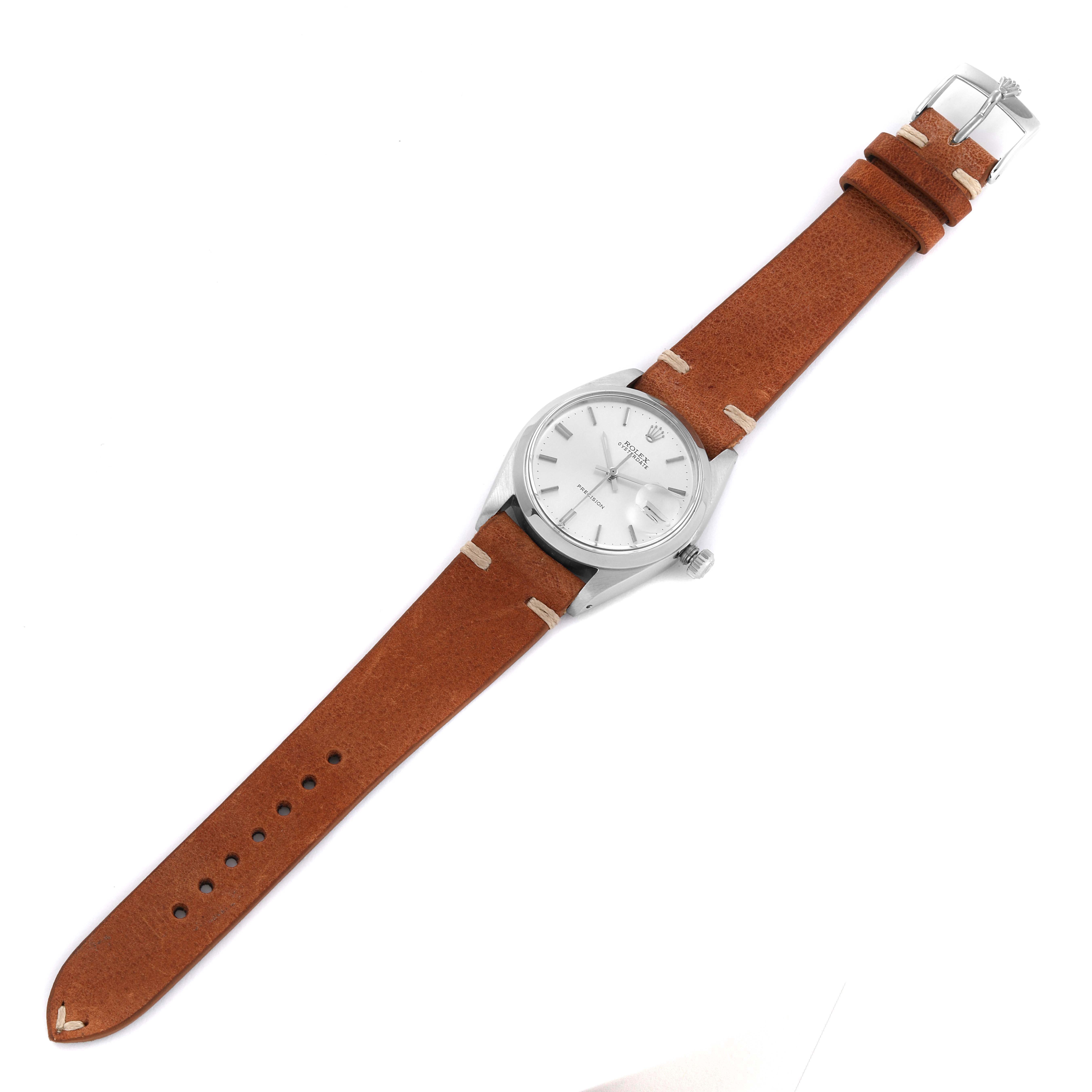 This image shows a top-down view of a Vintage Collection Rolex watch with a brown leather strap and a silver case.