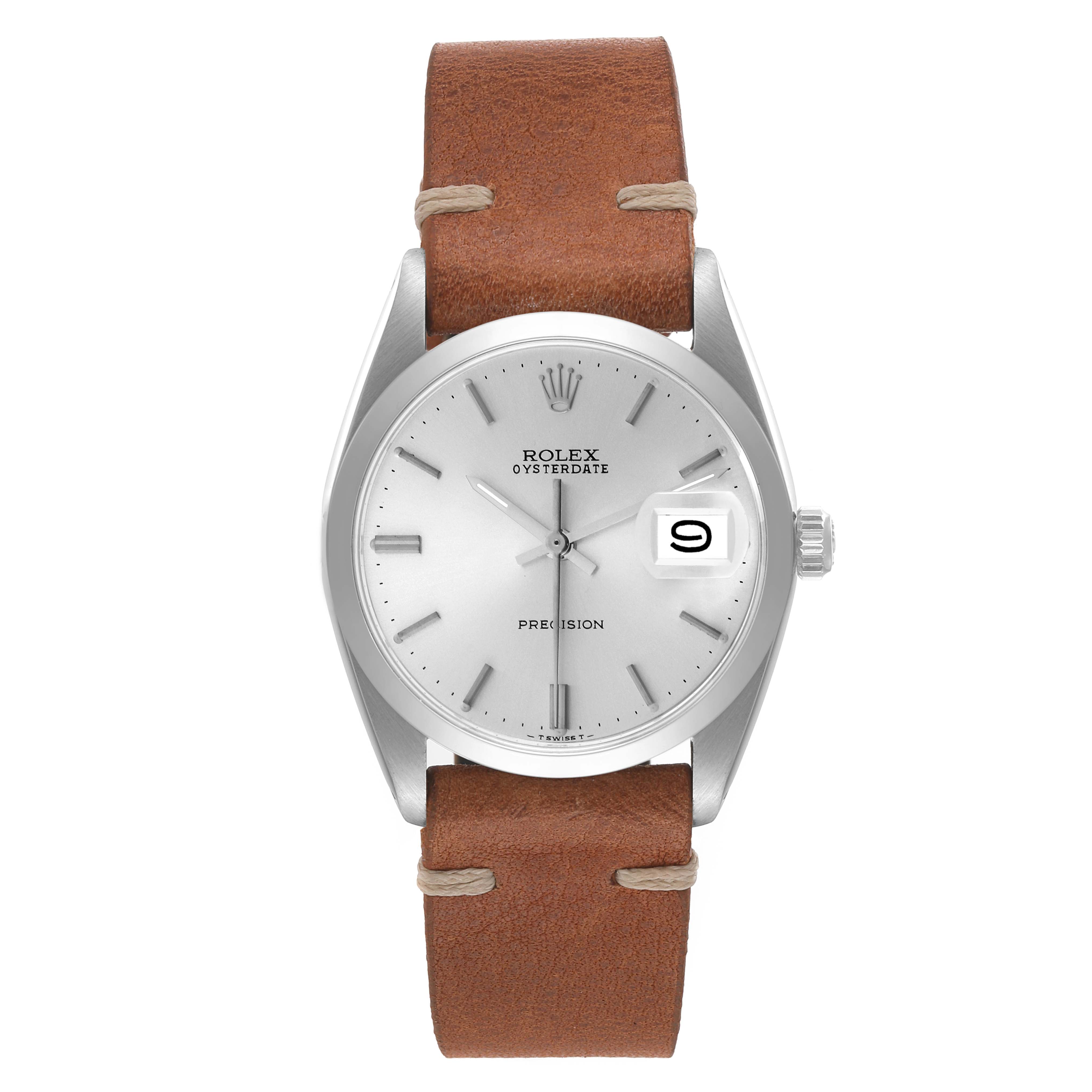 This is a frontal view of a Rolex Vintage Collection 6694 Men's Stainless Steel Silver Dial 6694 Men's Stainless Steel Silver Dial Oysterdate watch with a leather strap and a magnified date window.