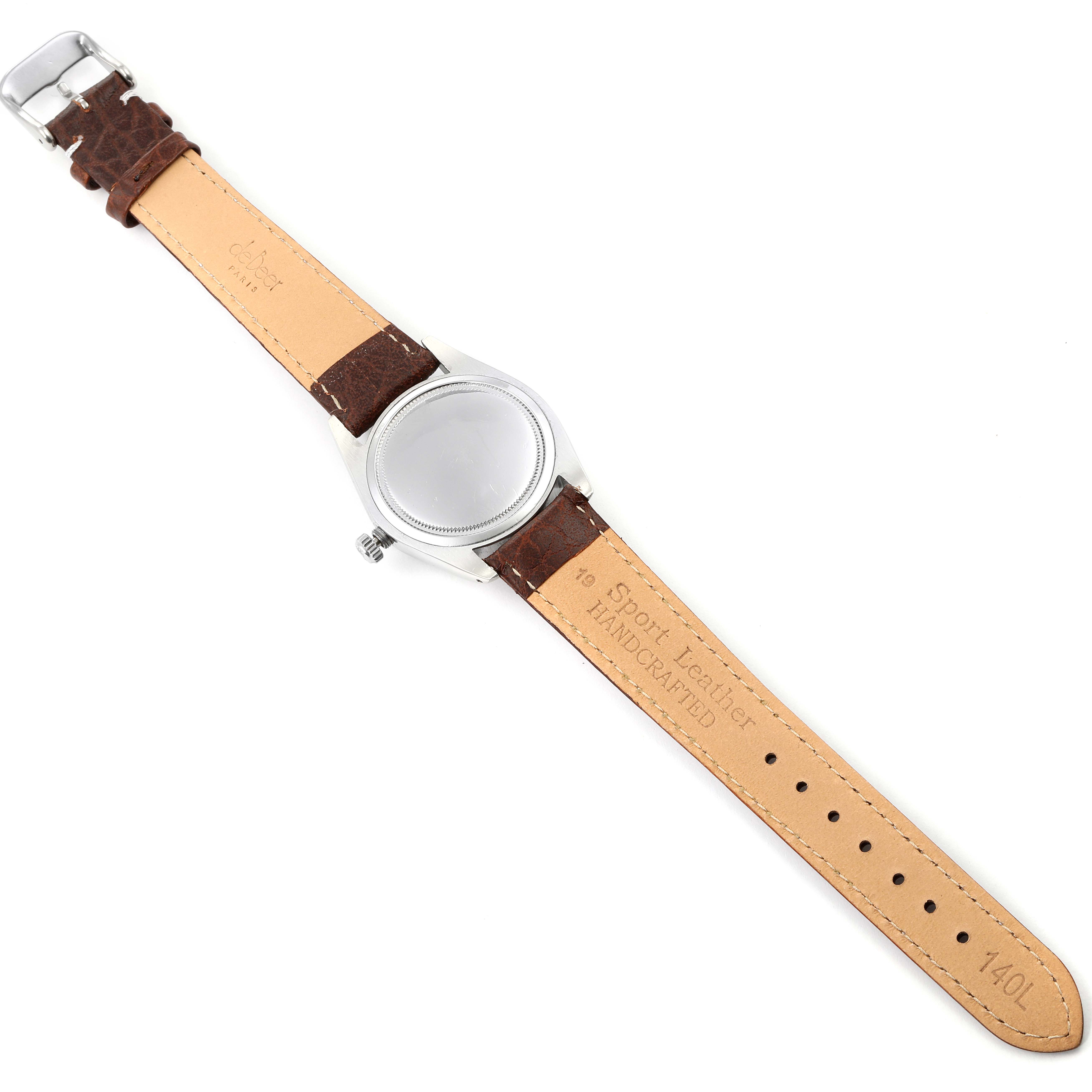 The image shows the back side of a Vintage Collection model by Rolex, featuring the case and leather strap.