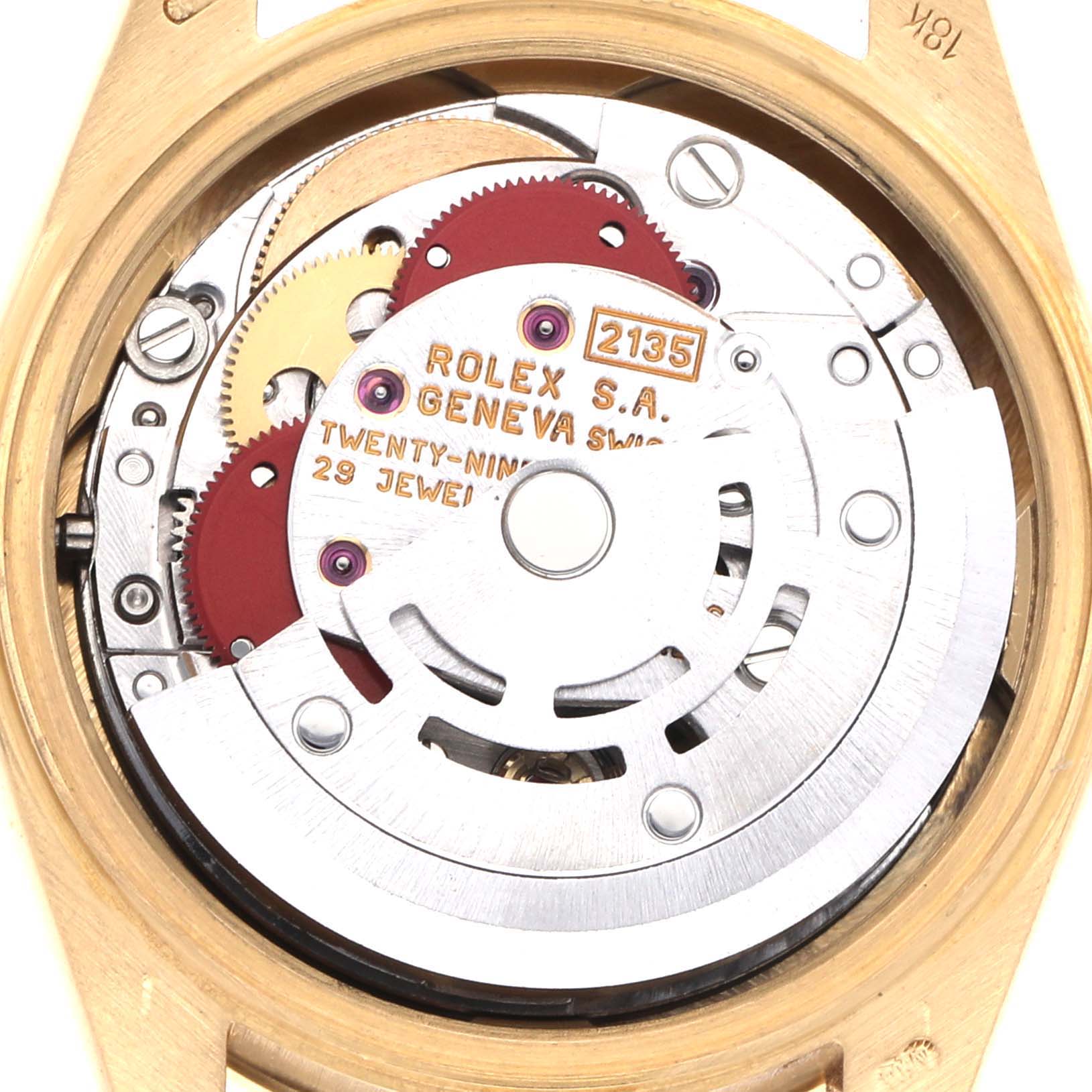 The image shows the movement of a Rolex President 69288 Women's Yellow Gold Black Dial 69288 Women's Yellow Gold Black Dial model watch, viewed from the back, highlighting gears and jewels.