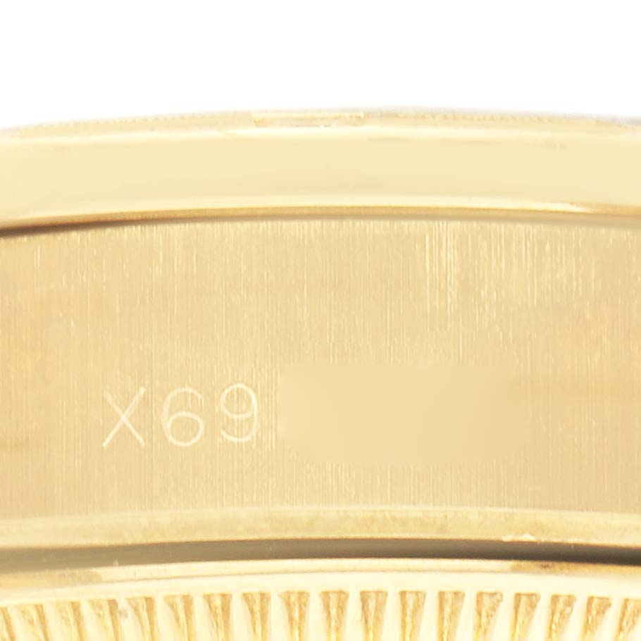 The image shows a close-up of the side of the Rolex President 69288 Women's Yellow Gold Black Dial 69288 Women's Yellow Gold Black Dial model, highlighting the engravings on the case.