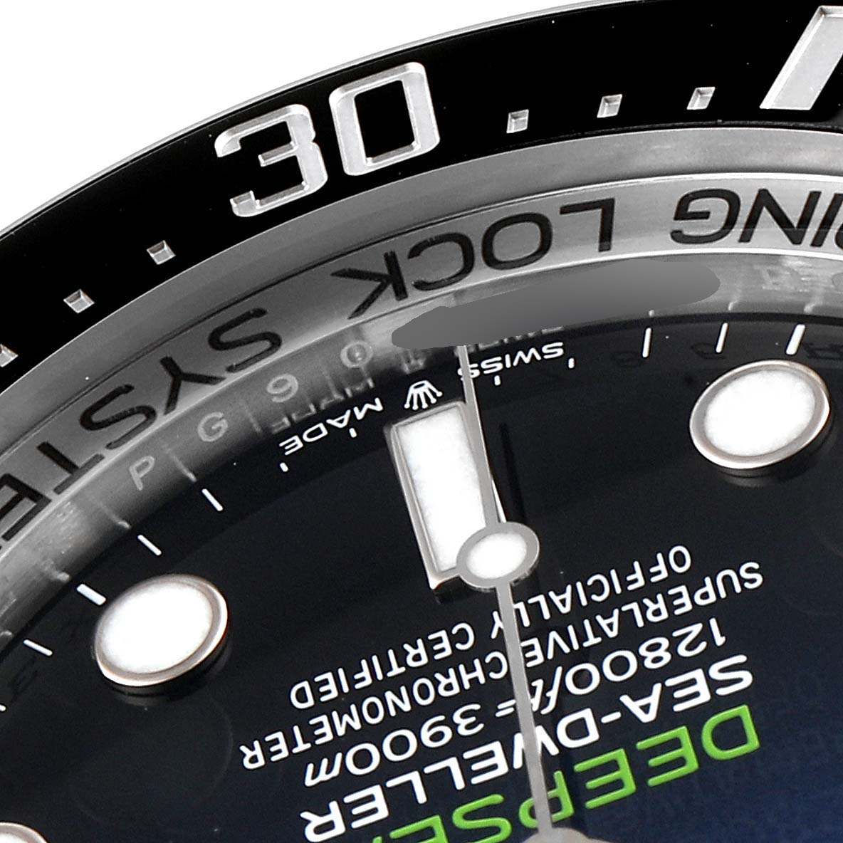 This close-up image shows part of the dial and bezel, including the 30-minute mark, on a Rolex Sea-Dweller 126660 Men's Stainless Steel Blue Dial 126660 Men's Stainless Steel Blue Dial watch.