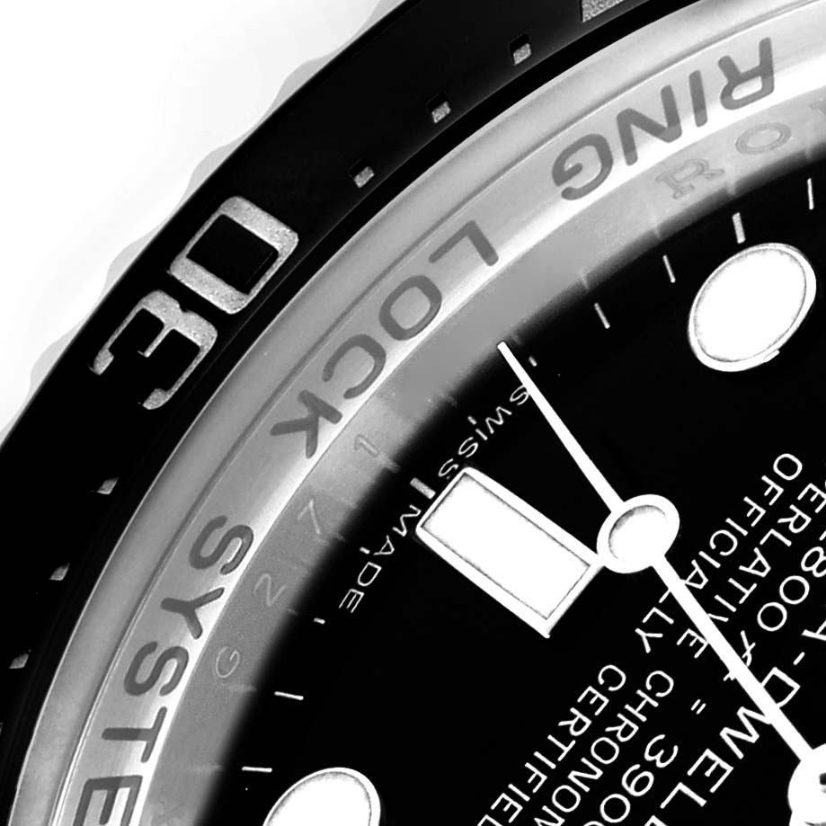 The image shows a close-up of the bezel and partial dial of the Rolex Sea-Dweller 116660 Men's Stainless Steel Black Dial 116660 Men's Stainless Steel Black Dial watch, highlighting the "Ring Lock System."