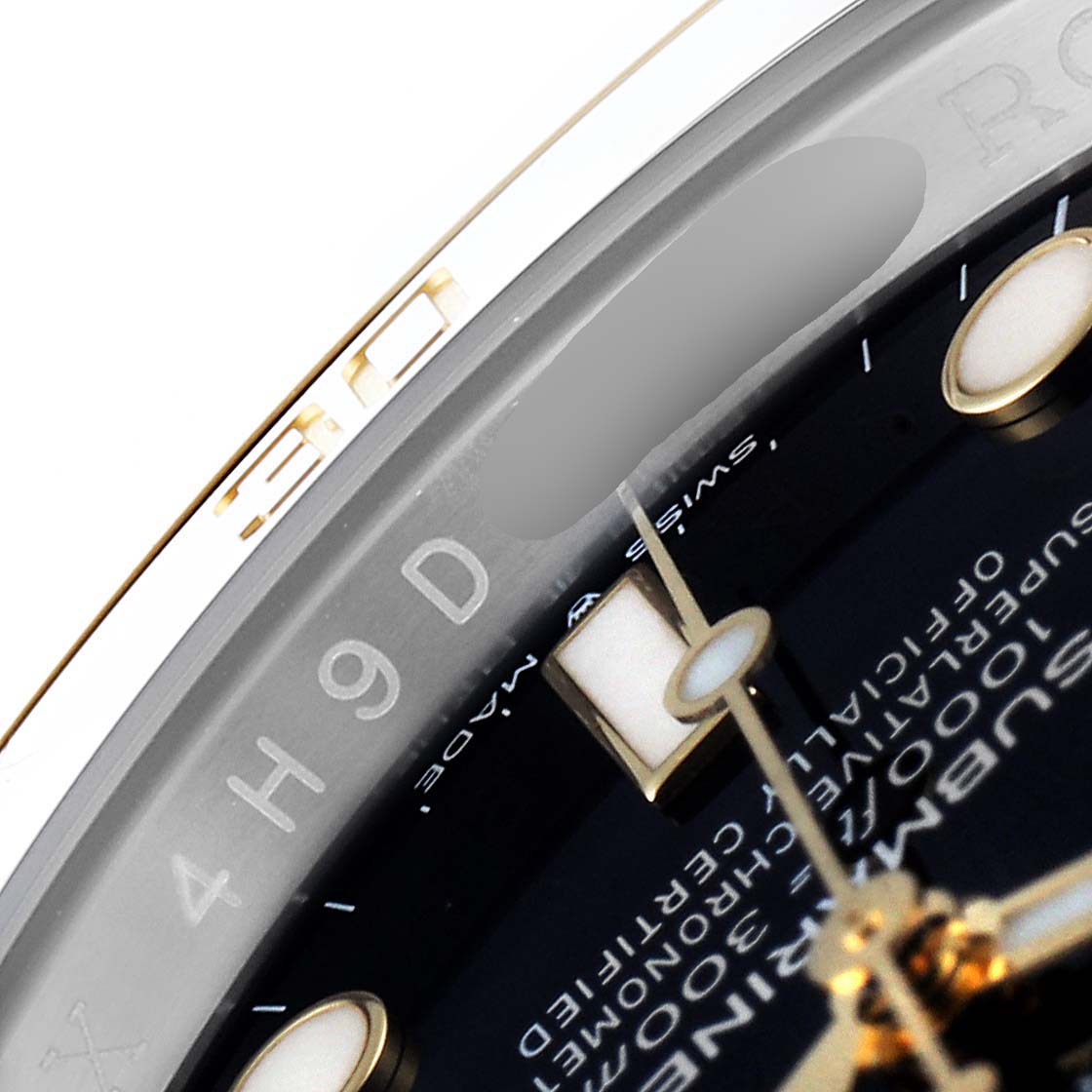 The image shows a close-up of the dial and rehaut of a Rolex Submariner 126613 Men's Steel and Gold (two tone) Black Dial 126613 Men's Steel and Gold (two tone) Black Dial watch, focusing on the engraved serial number and details.