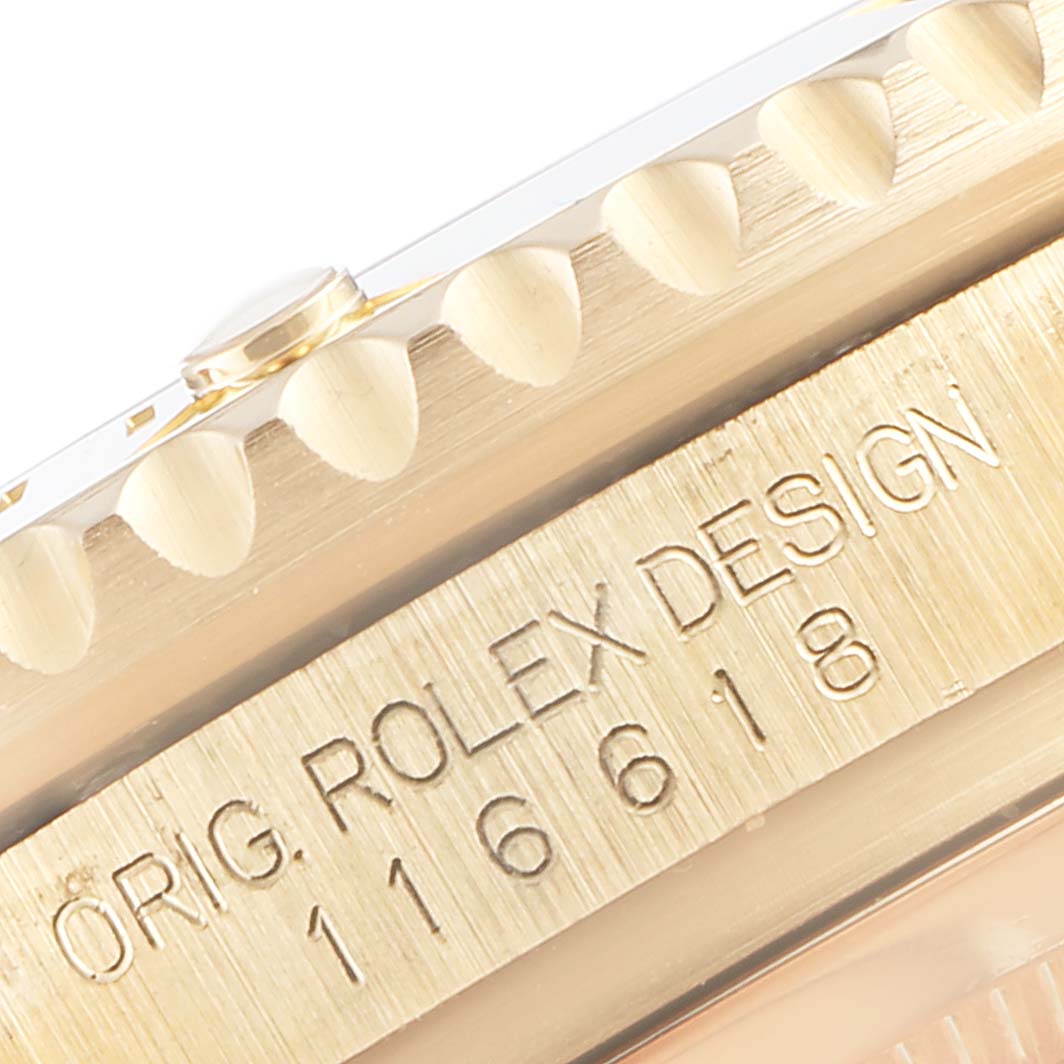 This image shows a close-up of the engraved side of a Rolex Submariner 116618 Men's Yellow Gold Black Dial 116618 Men's Yellow Gold Black Dial model, featuring the model number 116618.