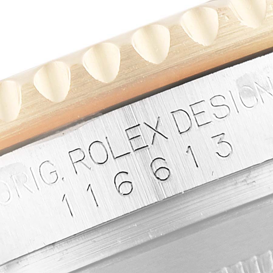 The image shows a close-up of the bezel and engraved case side of the Rolex Submariner 116613 Men's Steel and Gold (two tone) Blue Dial 116613 Men's Steel and Gold (two tone) Blue Dial model, displaying "ROLEX DESIGN" and the reference number.