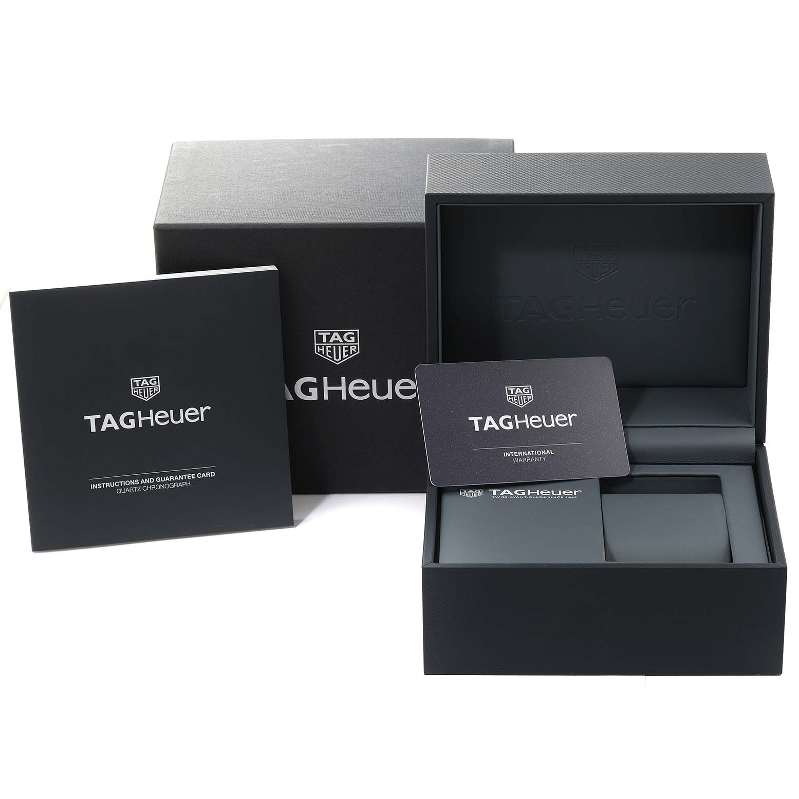 This image shows the packaging, instruction manual, and warranty card for a Carrera model by Tag Heuer from a front angle.