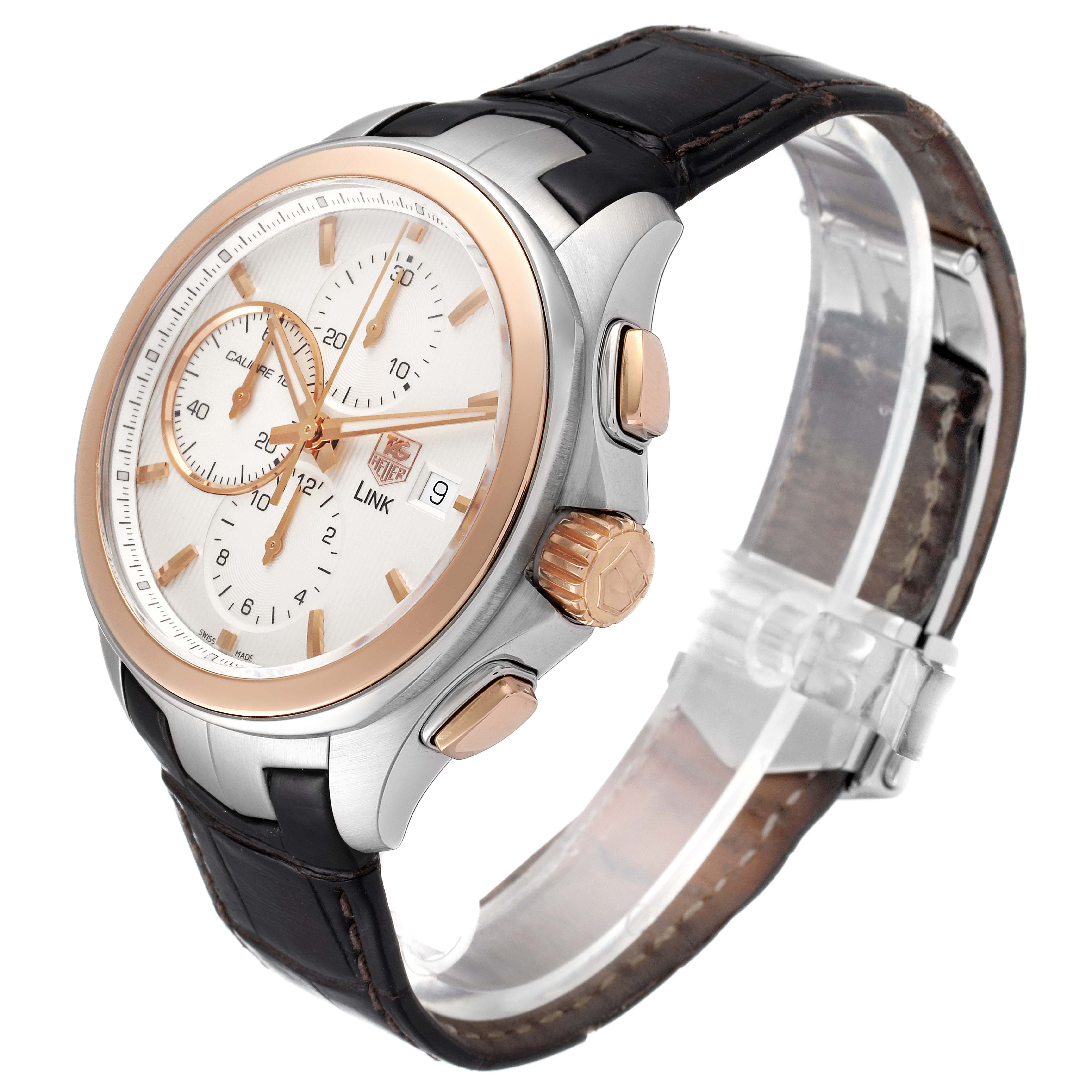 This Tag Heuer Link CAT2050.FC6322 Men's Steel and Gold (two tone) Silver Dial CAT2050.FC6322 Men's Steel and Gold (two tone) Silver Dial watch is shown at an oblique angle, displaying its face, crown, pushers, and leather strap.