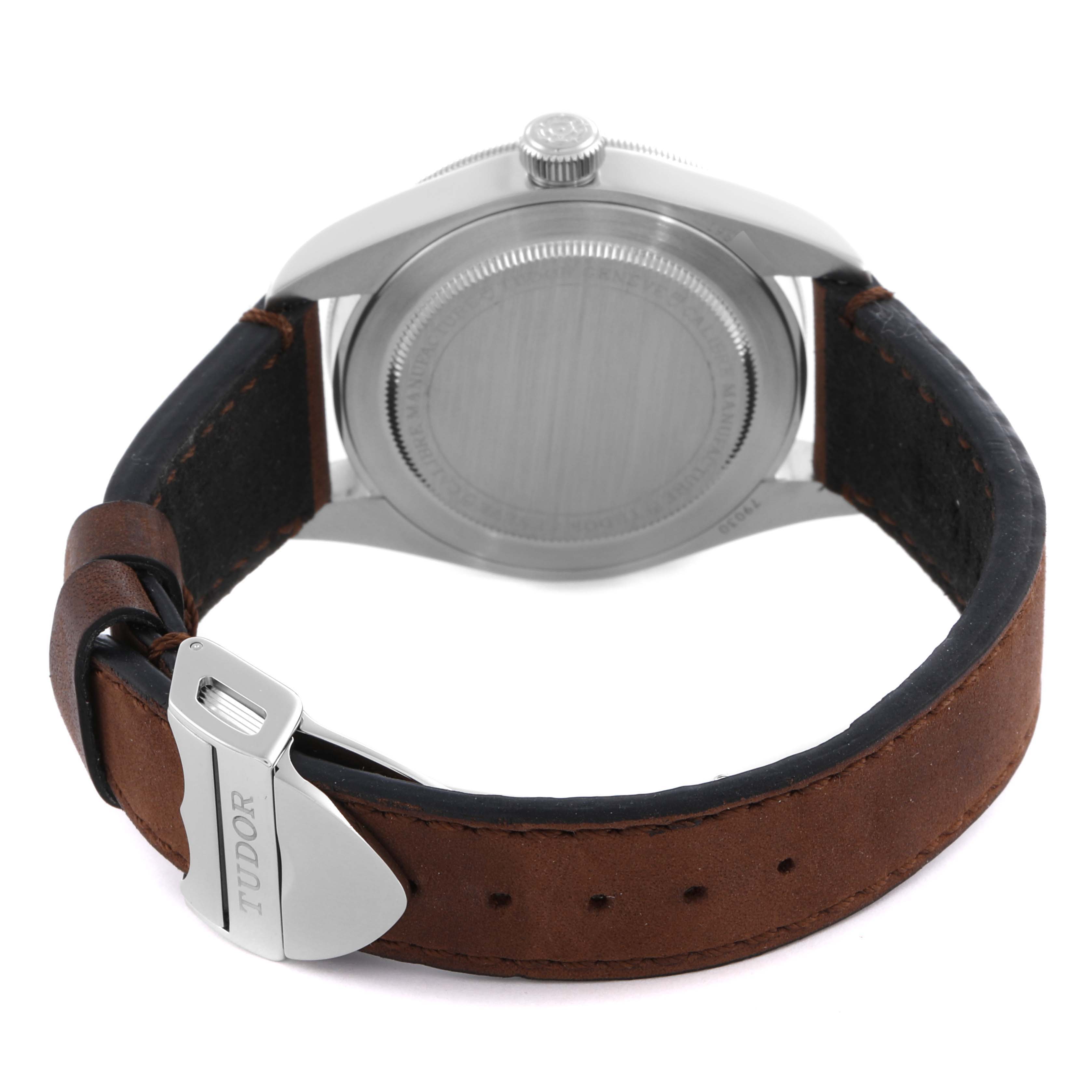 The Tudor Heritage Black Bay 79030N-0002 Men's Stainless Steel Black Dial 79030N-0002 Men's Stainless Steel Black Dial watch is shown from the back, highlighting the case back, crown, and leather strap with the buckle.