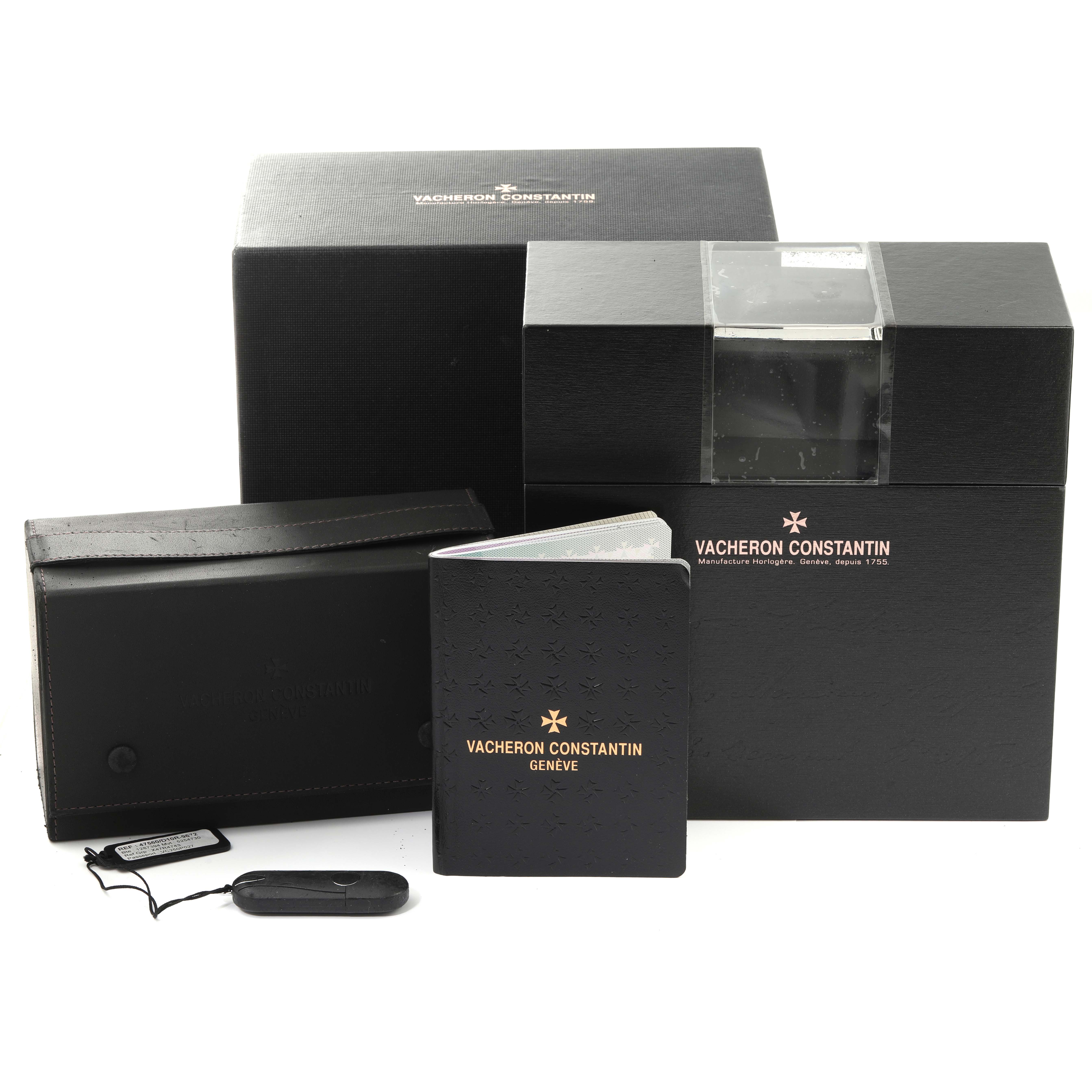 The image shows packaging and accessories for the Vacheron Constantin Overseas 47560/D01R-9672 Women's Rose Gold Silver Dial 47560/D01R-9672 Women's Rose Gold Silver Dial model, including a box, pouch, manual, and tag.