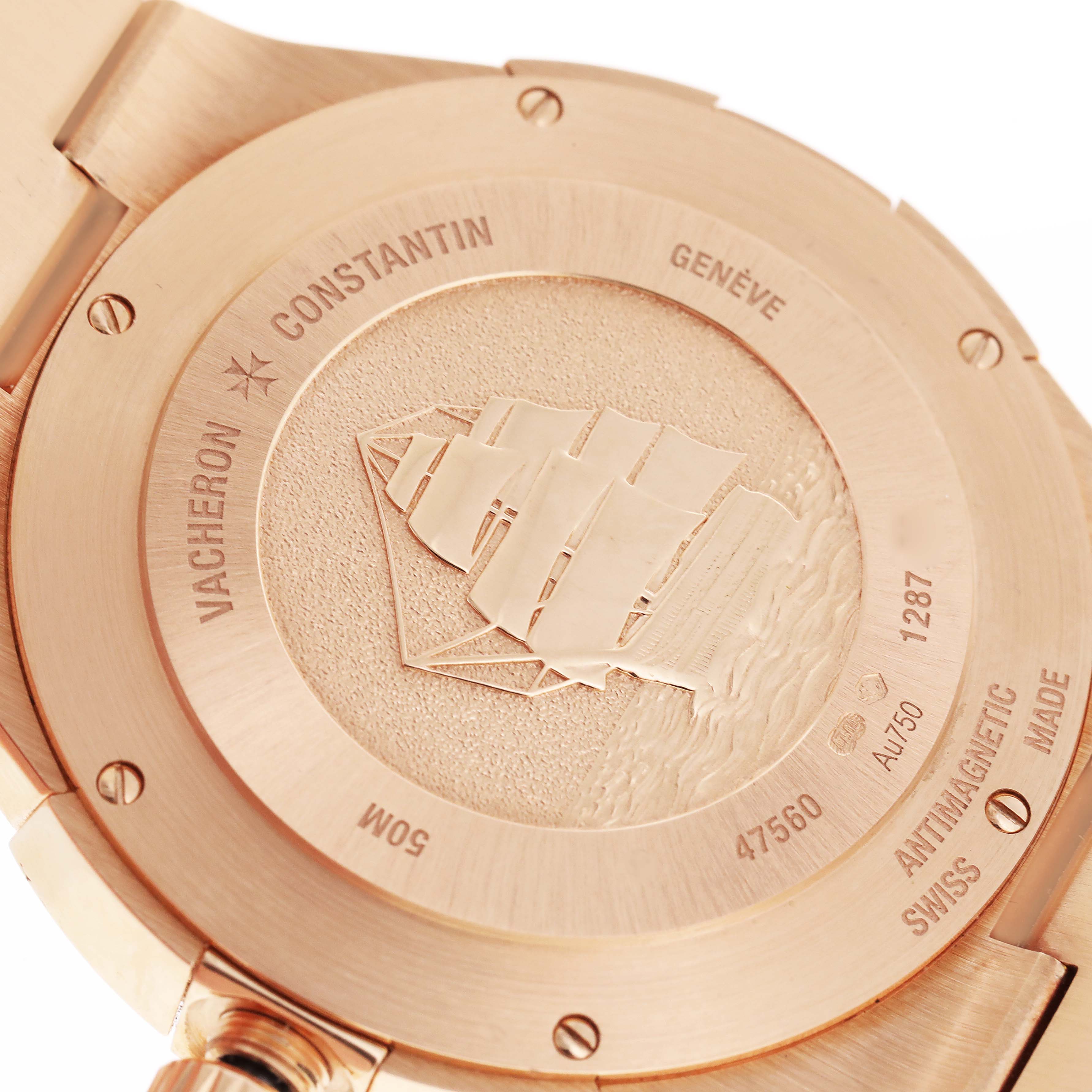 The image shows the back case of a Vacheron Constantin Overseas 47560/D01R-9672 Women's Rose Gold Silver Dial 47560/D01R-9672 Women's Rose Gold Silver Dial watch, highlighting the engravings and logo.
