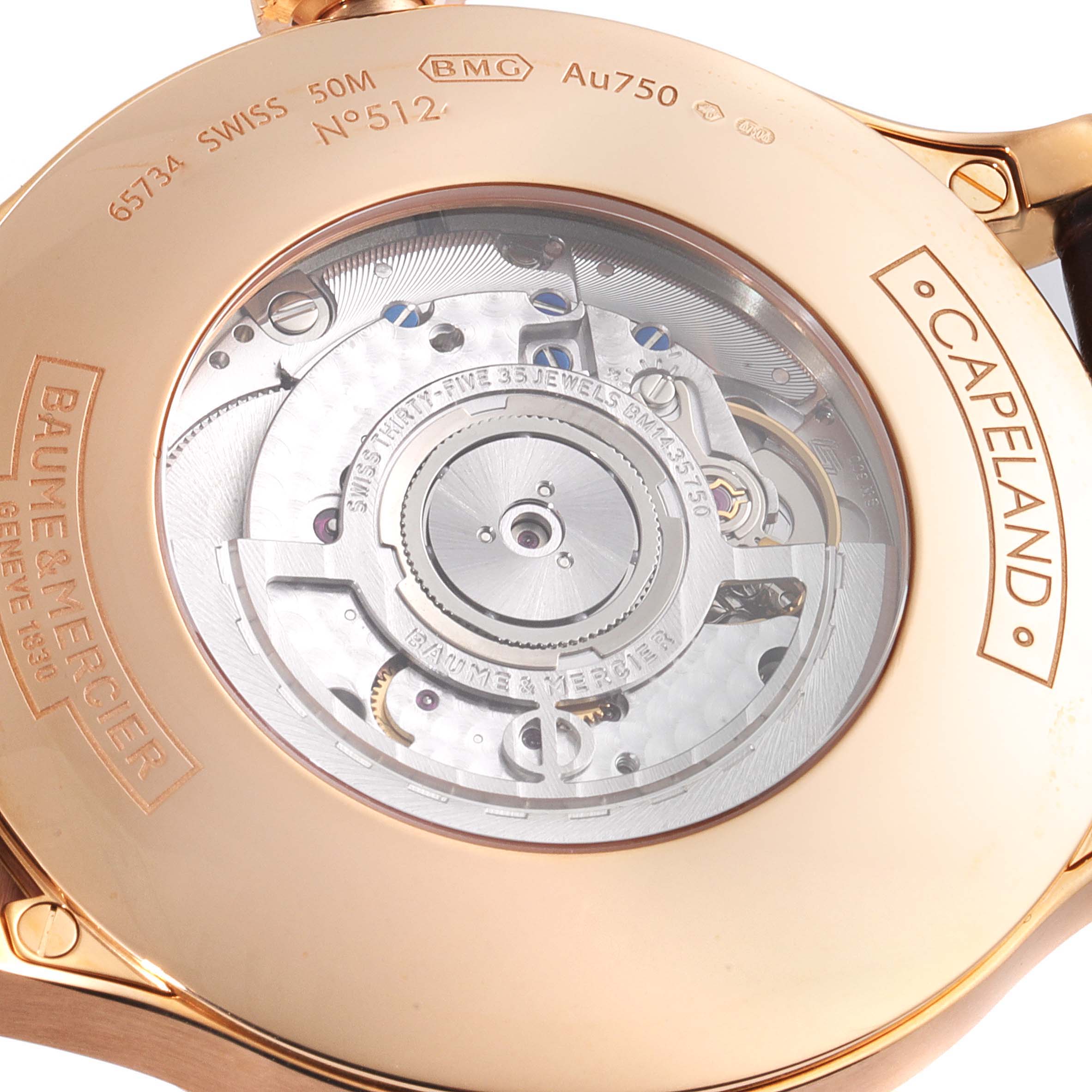 The image shows the back of a Baume & Mercier Capeland M0A10107 Men's Rose Gold Silver Dial M0A10107 Men's Rose Gold Silver Dial watch, highlighting the intricate movement visible through a transparent case back.