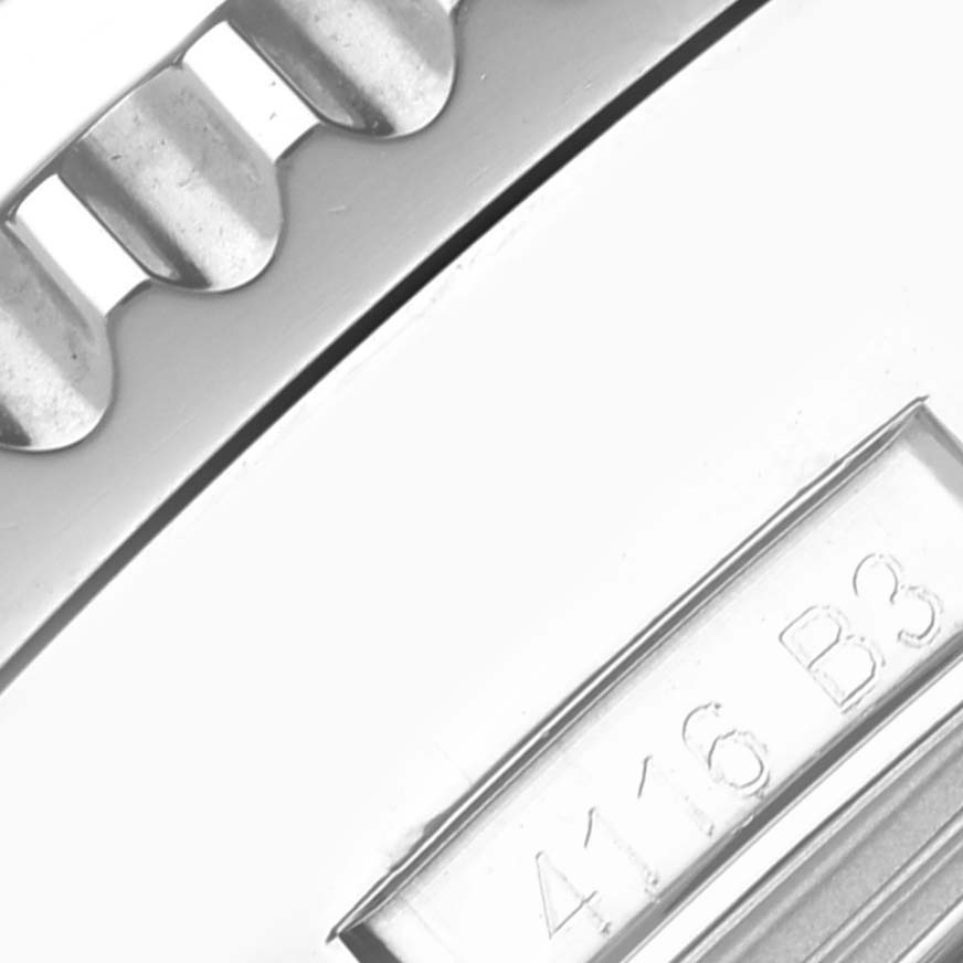The image shows a close-up of the bezel and edge of a Breitling Navitimer AB0127E3/BE81 Men
s Stainless Steel Black Dial AB0127E3/BE81 Men
s Stainless Steel Black Dial watch, highlighting a section with a reference number.