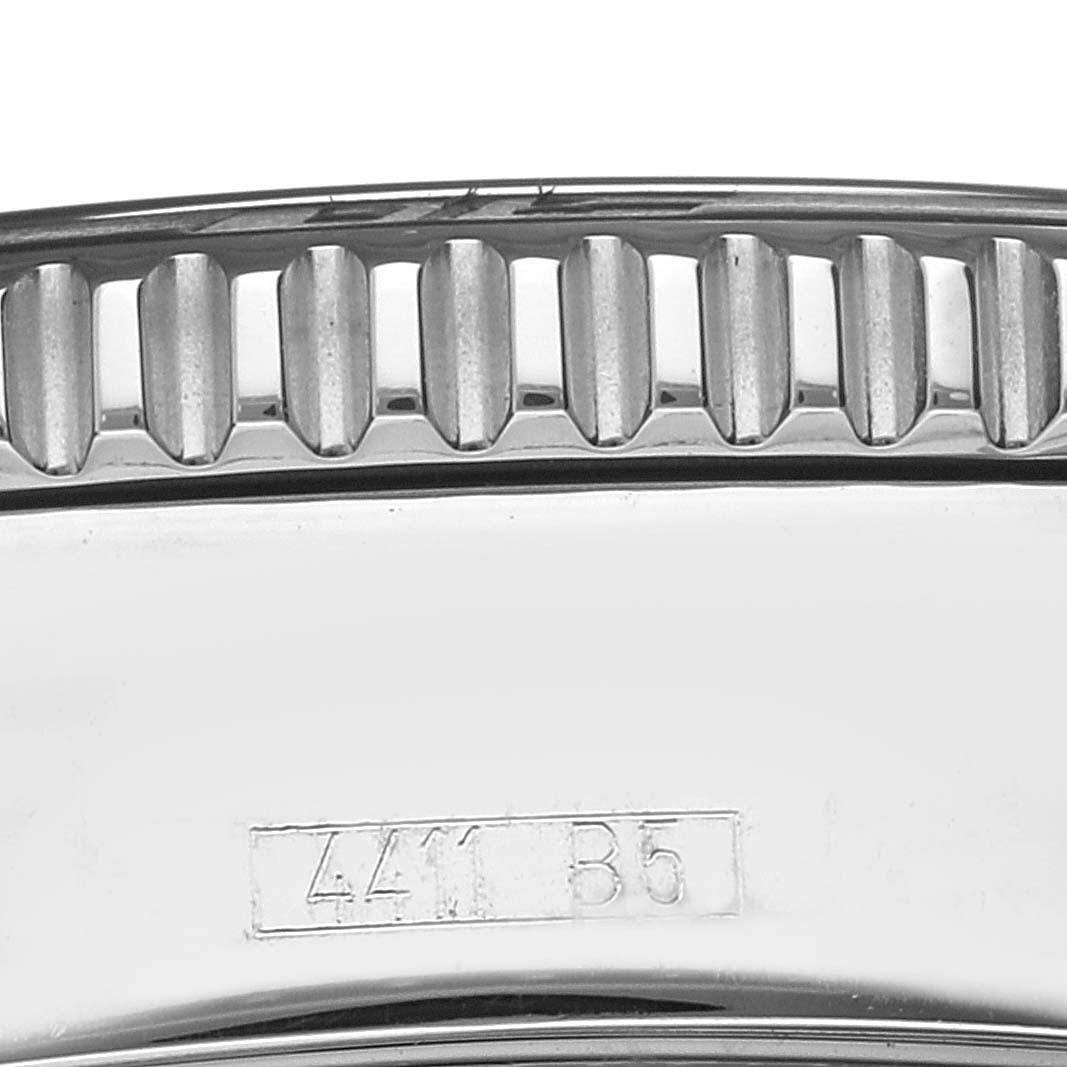 Close-up of the side of a Breitling Superocean A17364 Men's Stainless Steel Black Dial A17364 Men's Stainless Steel Black Dial watch case, highlighting the bezel's ridged edge and some inscribed marks.