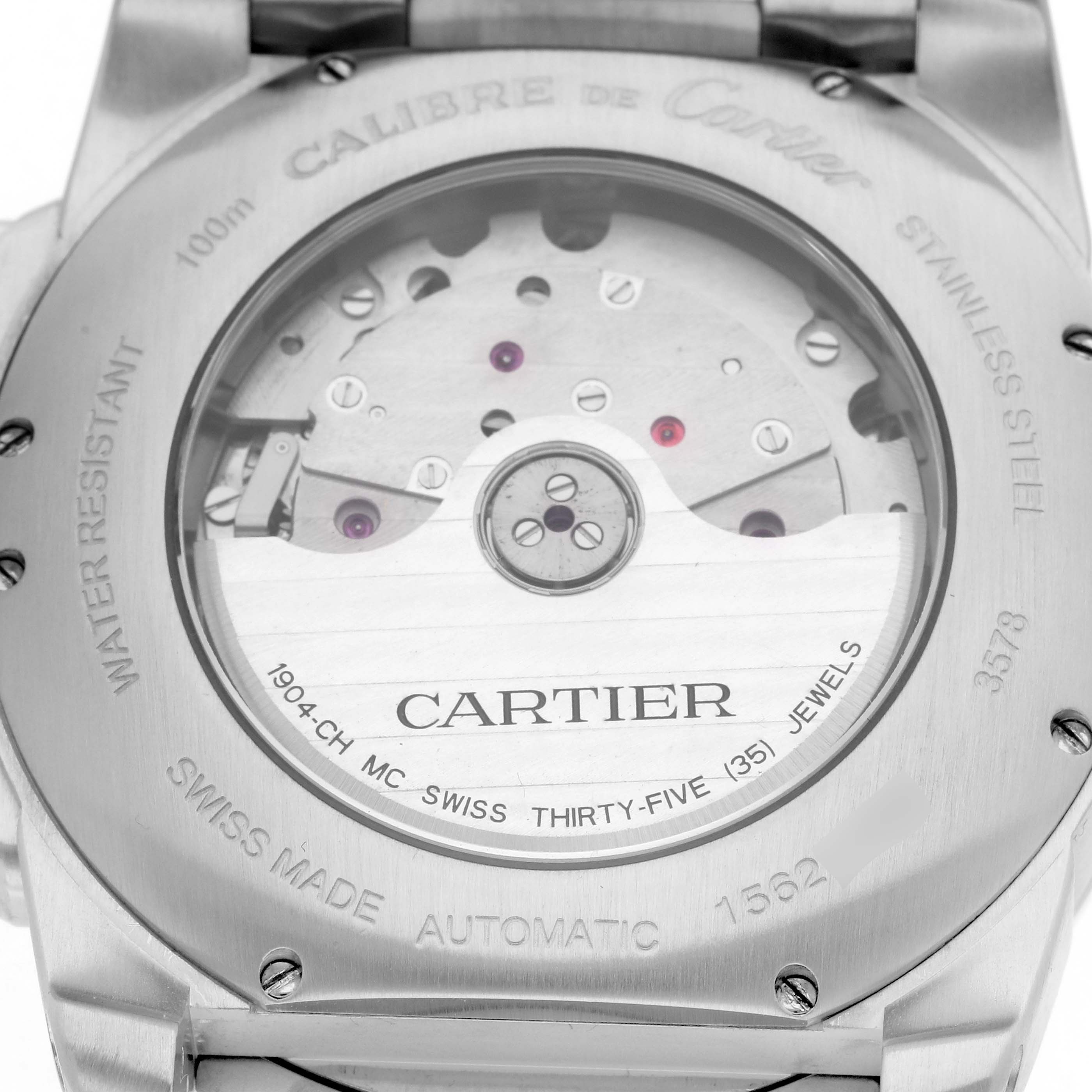 The image shows the case back of the Calibre de Cartier watch, displaying its automatic movement and descriptive engravings.