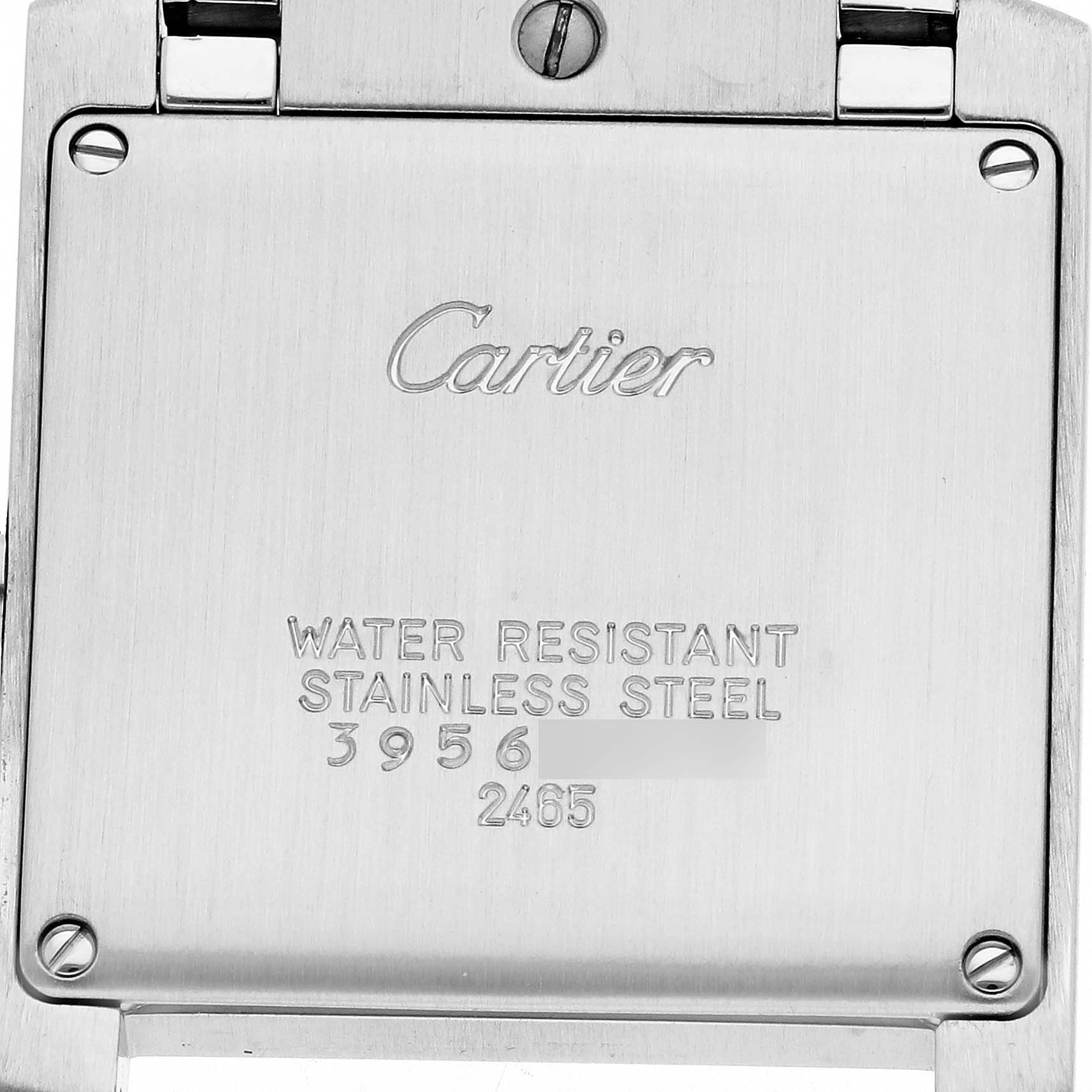 The image shows the back case of a Cartier Tank Française watch, highlighting engraving details and screws.