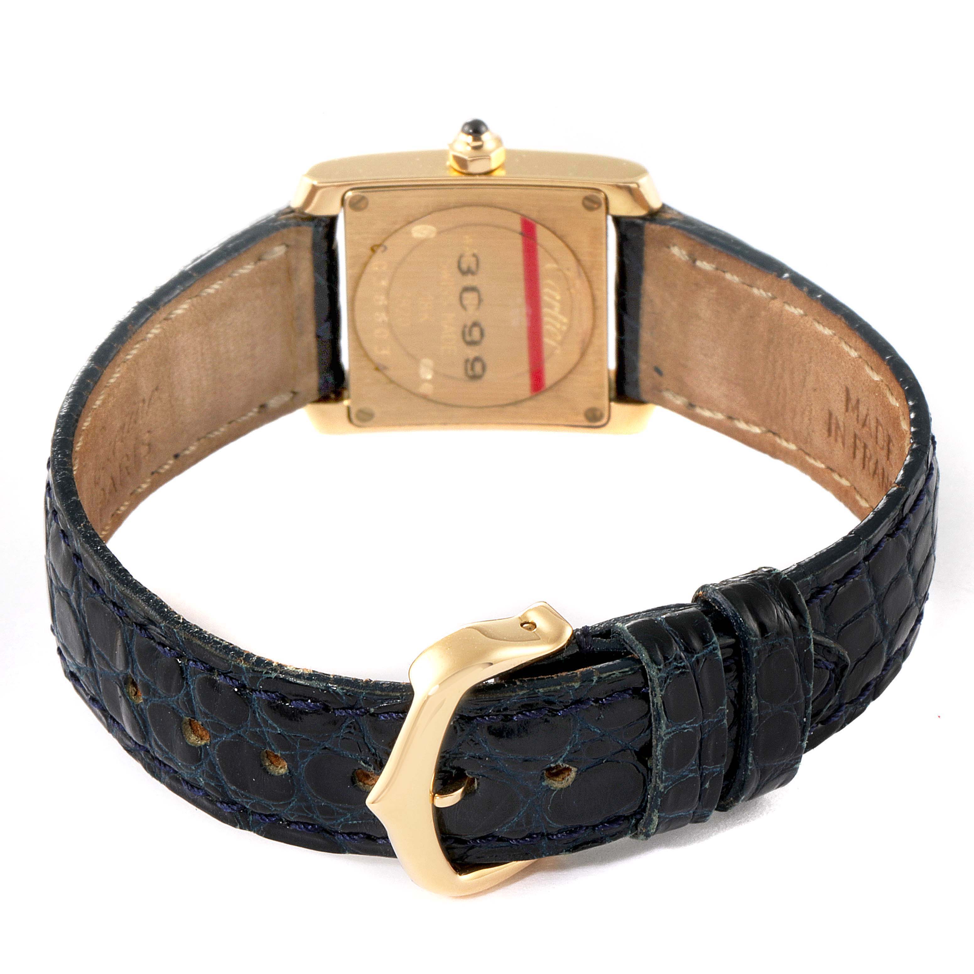 The image shows the back view of a Cartier Tank Francaise W5000256 Women's Yellow Gold Silver Dial W5000256 Women's Yellow Gold Silver Dial watch with an open black leather strap and gold buckle.