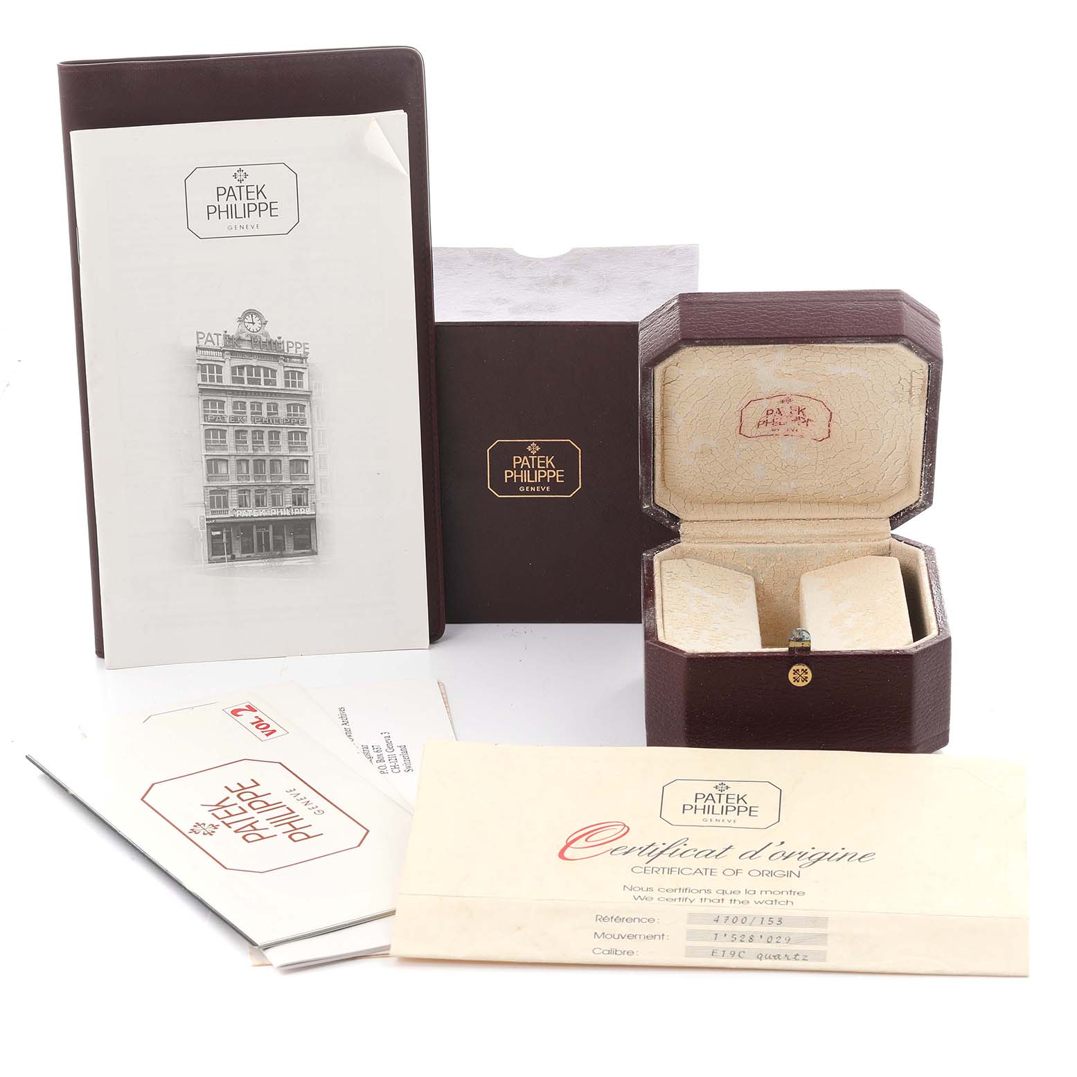 The image shows a Patek Philippe Nautilus 4700/153 Women's Yellow Gold Champagne Dial 4700/153 Women's Yellow Gold Champagne Dial watch box, certificate, and paperwork from a frontal angle.