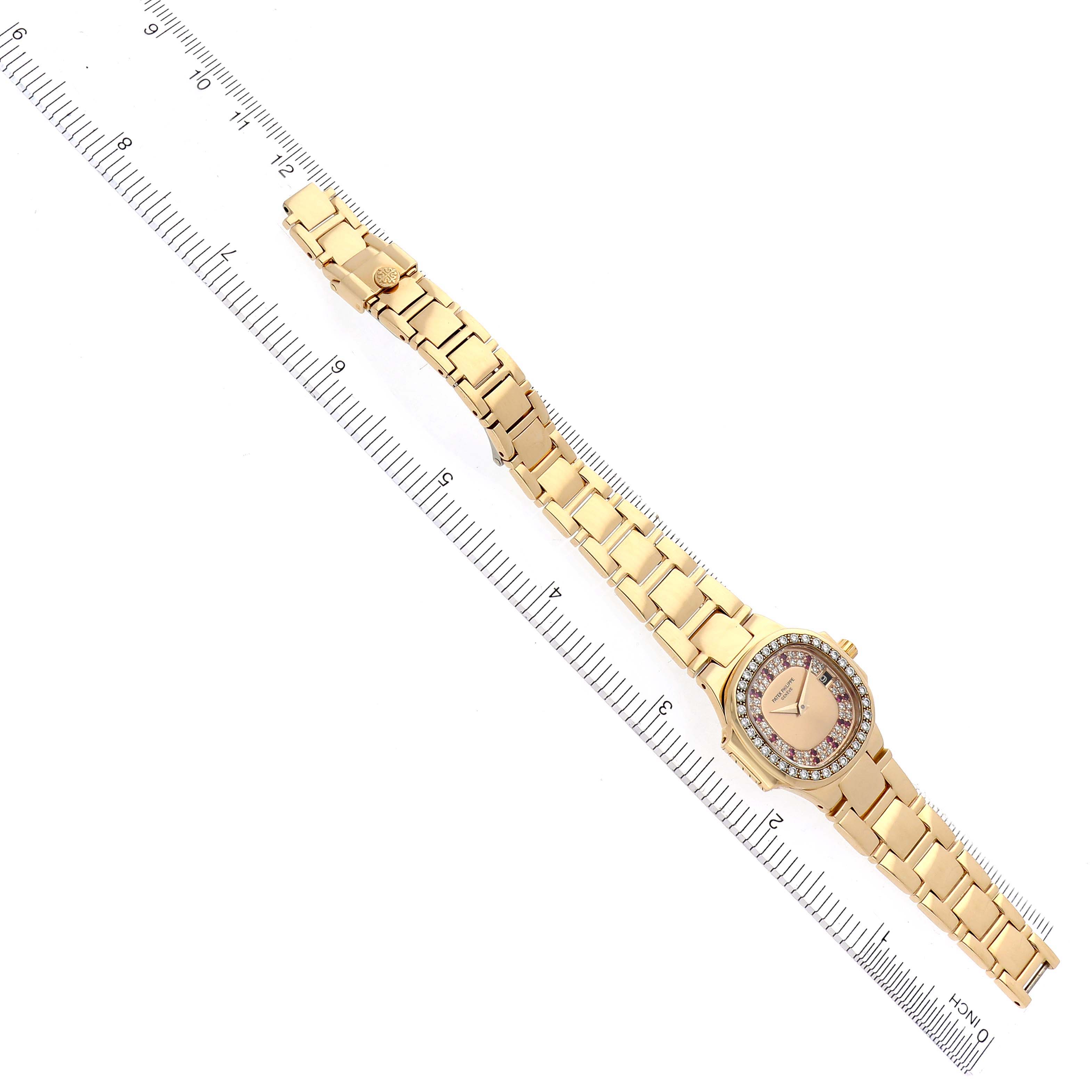 The Patek Philippe Nautilus 4700/153 Women's Yellow Gold Champagne Dial 4700/153 Women's Yellow Gold Champagne Dial watch is shown from above, displaying its bracelet and round diamond-set bezel.